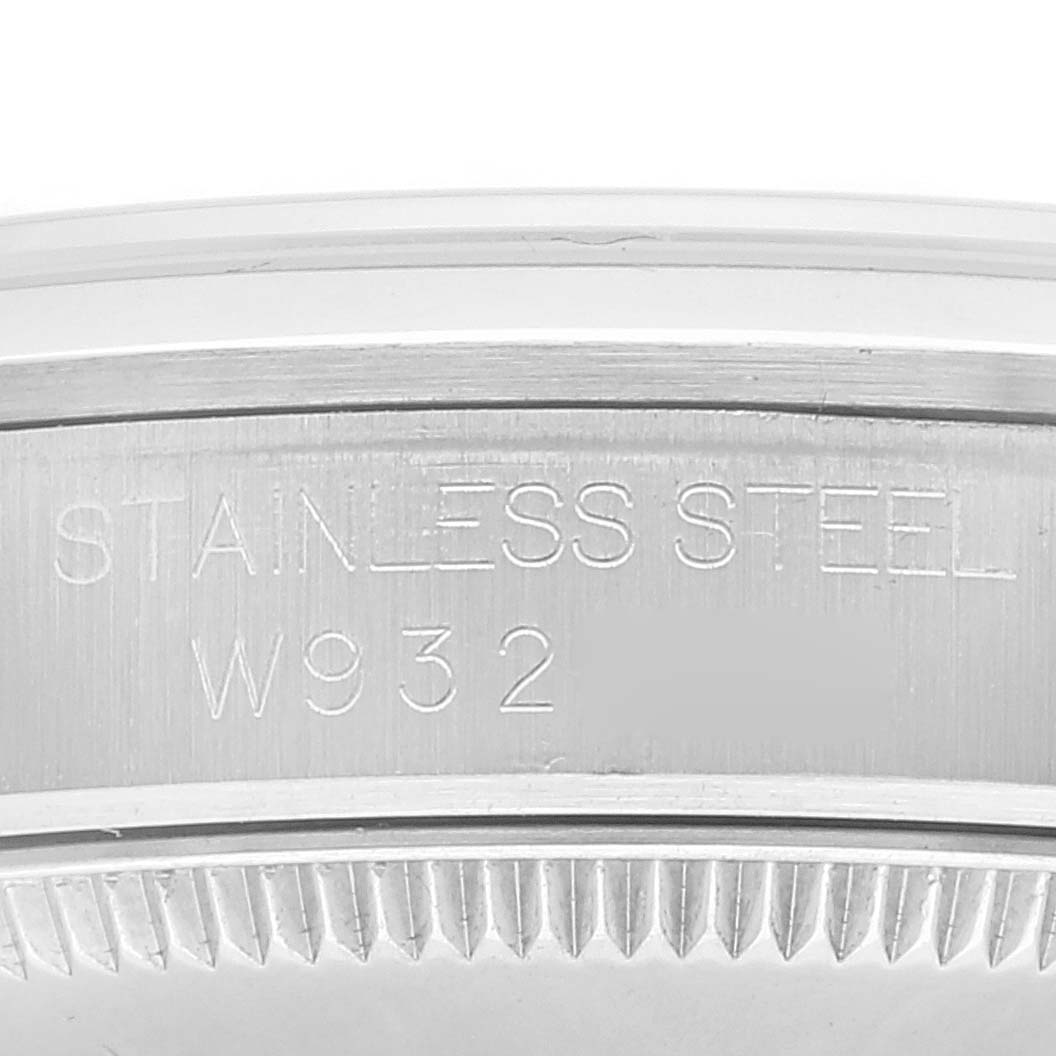 The image shows the engraved serial number and "STAINLESS STEEL" marking on the side of a Rolex Mid-Size 67480 Women
s Stainless Steel White Dial 67480 Women
s Stainless Steel White Dial watch case.
