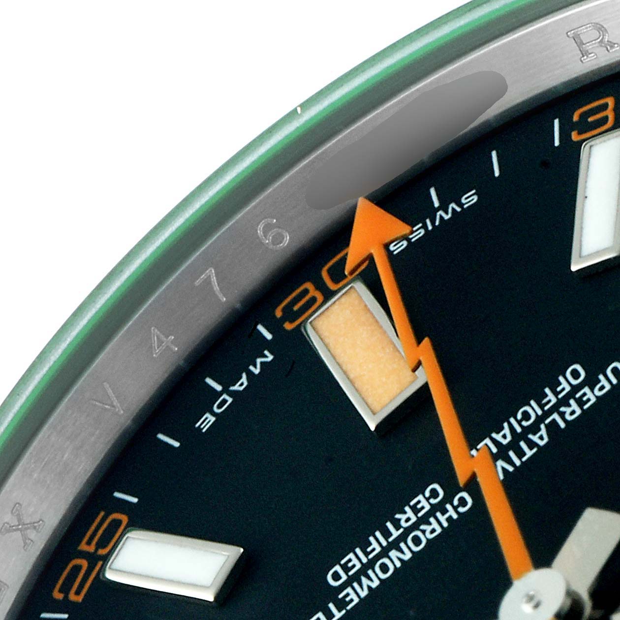 This close-up of a Rolex Milgauss 116400V Men
s Stainless Steel Black Dial 116400V Men
s Stainless Steel Black Dial watch shows part of the dial, orange seconds hand, and some numerals on the bezel.