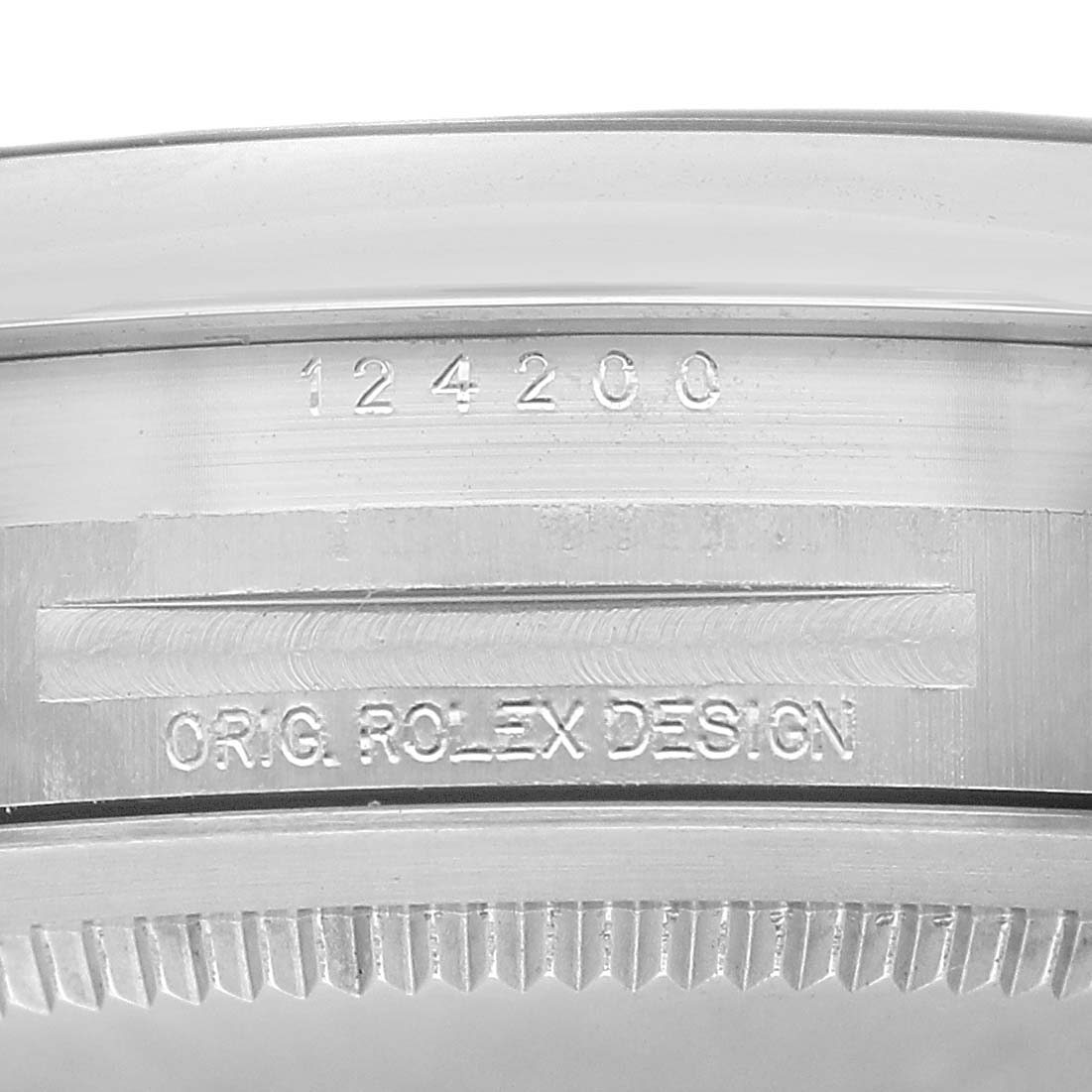 The image shows the side engraving on the case of a Rolex Oyster Perpetual 124200 Men's Stainless Steel Blue Dial watch, including a serial number.