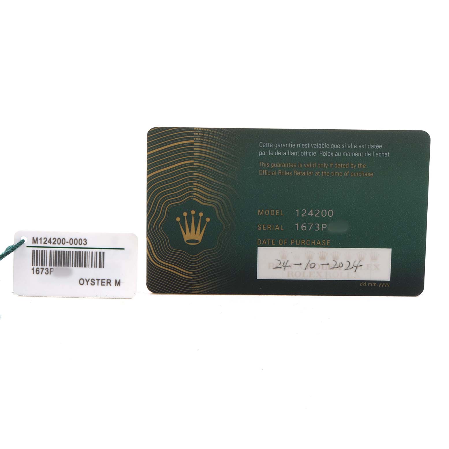 The image shows a warranty card and a tag for the Rolex Oyster Perpetual 124200 Men's Stainless Steel Blue Dial model, with model and serial numbers visible.