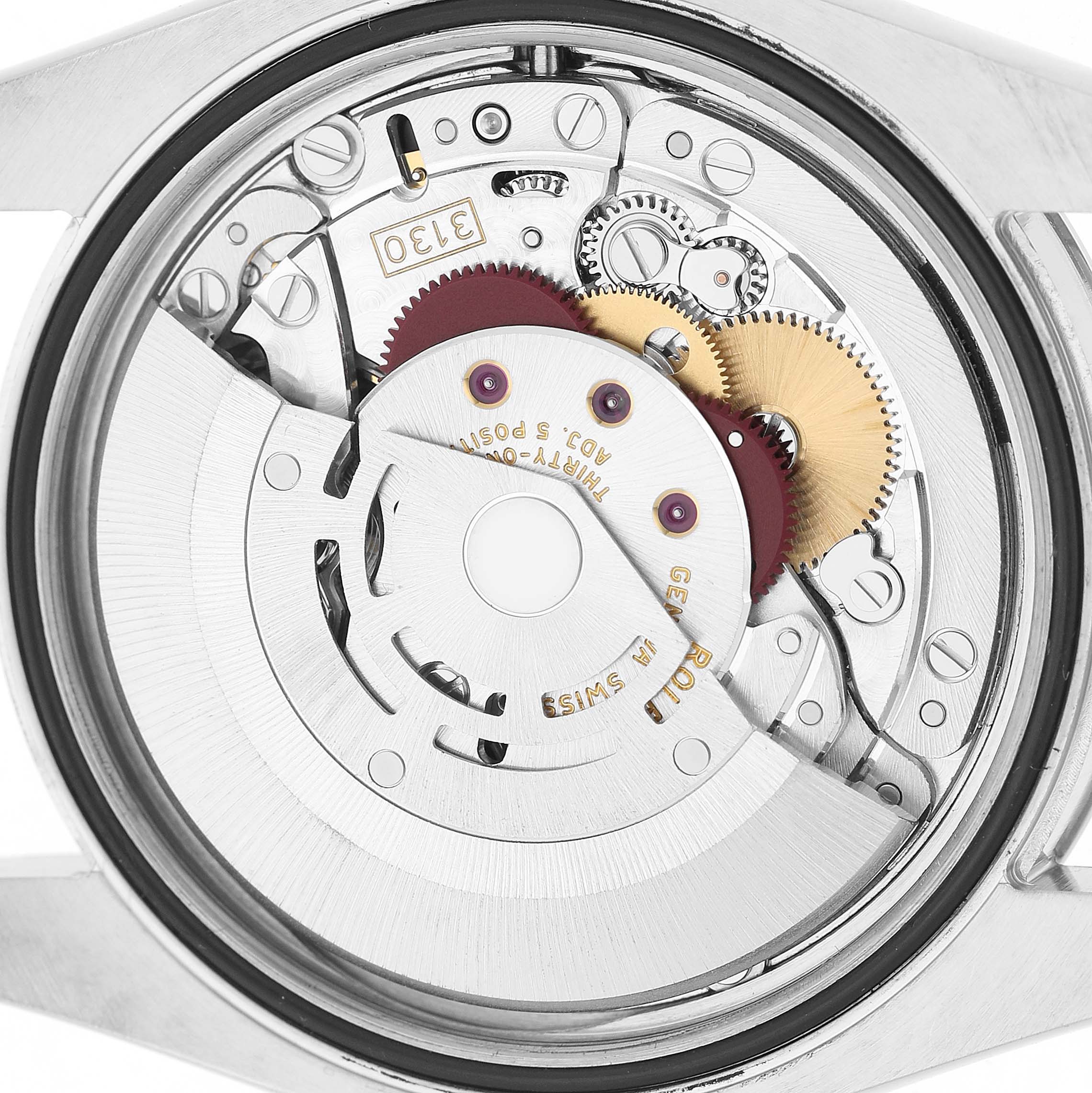 This image shows the movement mechanism of a Rolex Oyster Perpetual 116000 Men's Stainless Steel Silver Dial watch viewed from the back.