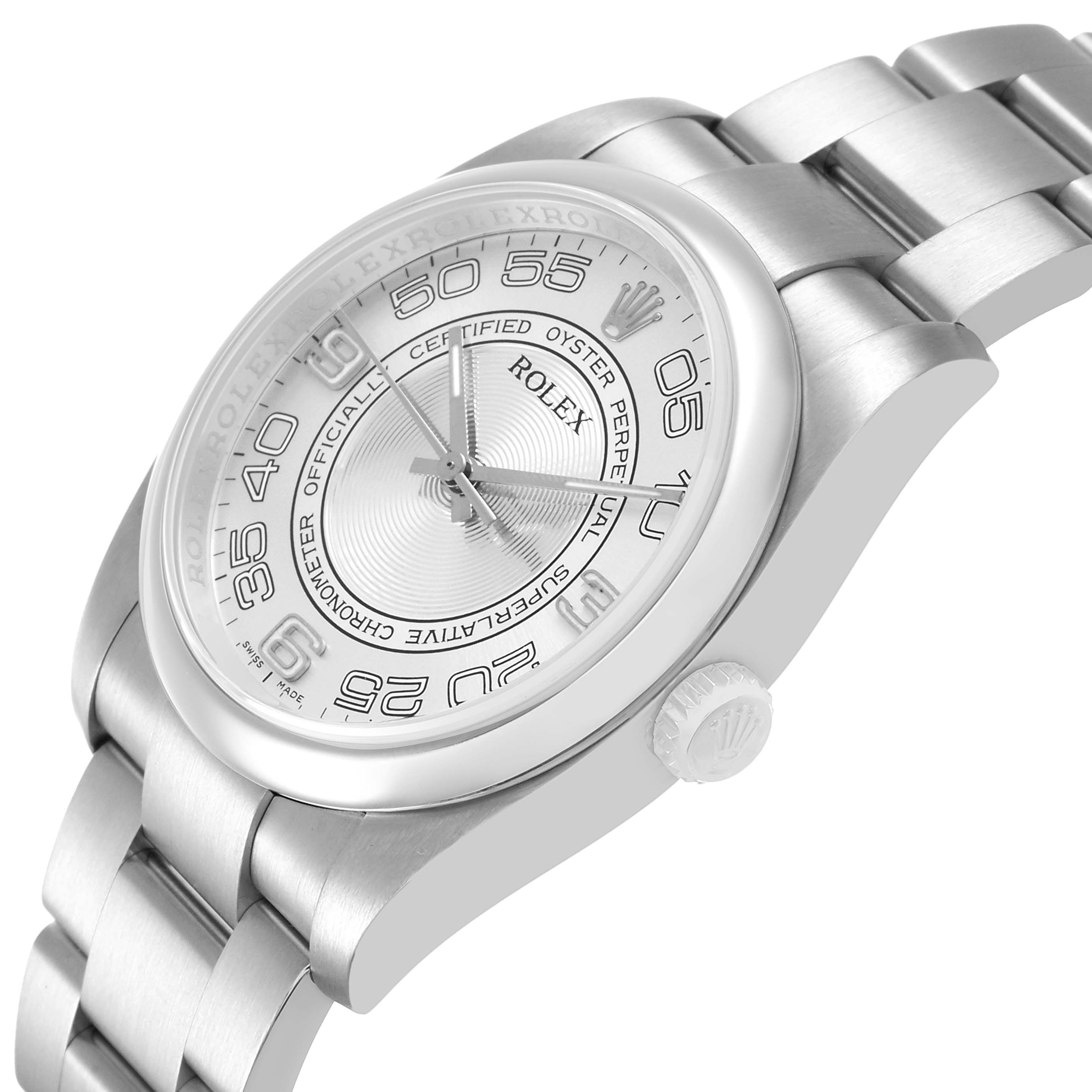 The image shows a side angle of the Rolex Oyster Perpetual 116000 Men's Stainless Steel Silver Dial, highlighting its bezel, dial, crown, and bracelet.