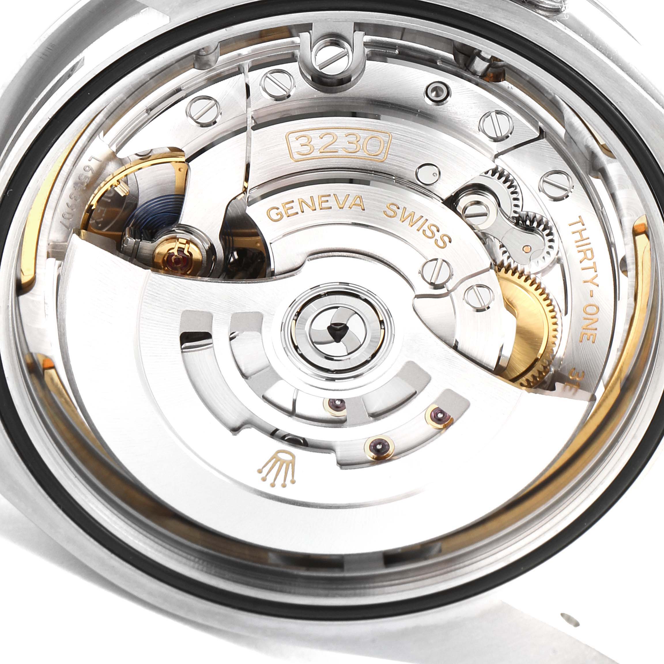 This image shows a close-up view of the movement of a Rolex Oyster Perpetual 114300 Men
s Stainless Steel Blue Dial 114300 Men
s Stainless Steel Blue Dial watch, highlighting its intricate mechanical parts.
