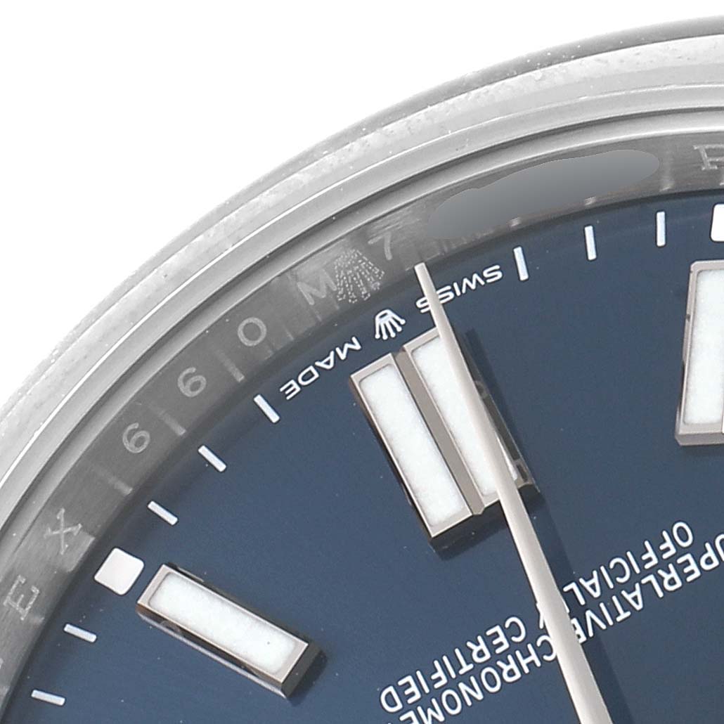 This close-up angle shows the dial and part of the bezel of a Rolex Oyster Perpetual 114300 Men
s Stainless Steel Blue Dial 114300 Men
s Stainless Steel Blue Dial watch.