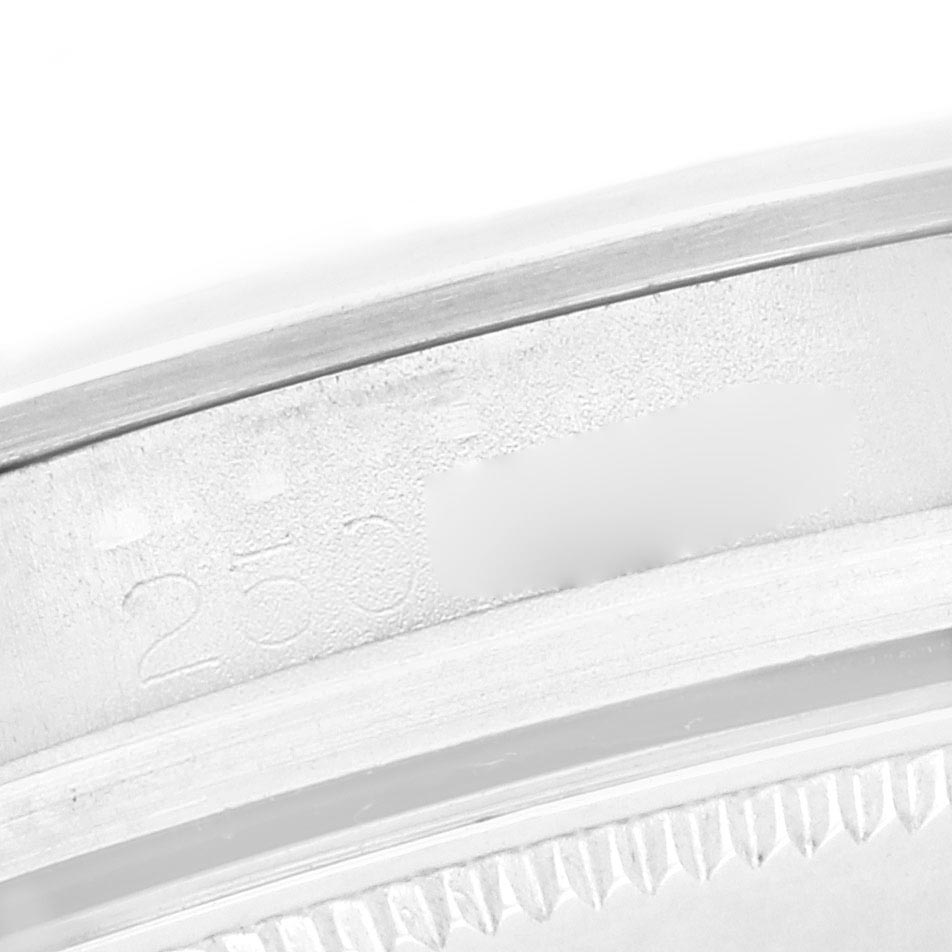 The image shows a close-up of the edge of a Vintage Collection Rolex watch, revealing the engraved serial number.