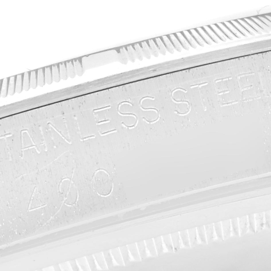 The image shows a close-up of the engraved bezel edge of a Rolex Vintage Collection 6427 Men
s Stainless Steel Silver Dial 6427 Men
s Stainless Steel Silver Dial watch, highlighting "STAINLESS STEEL" text.