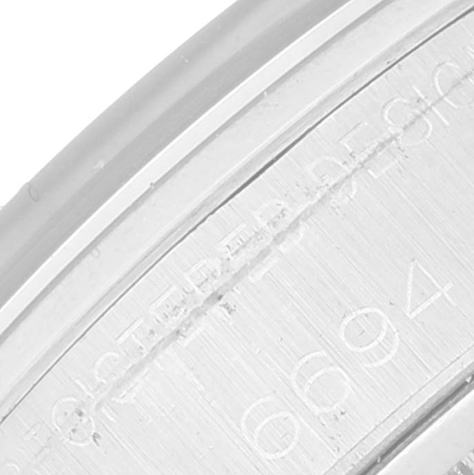 The image shows an extreme close-up of the case side engravings on a Rolex Date 6694 Men's Stainless Steel Black Dial 6694 Men's Stainless Steel Black Dial watch model.
