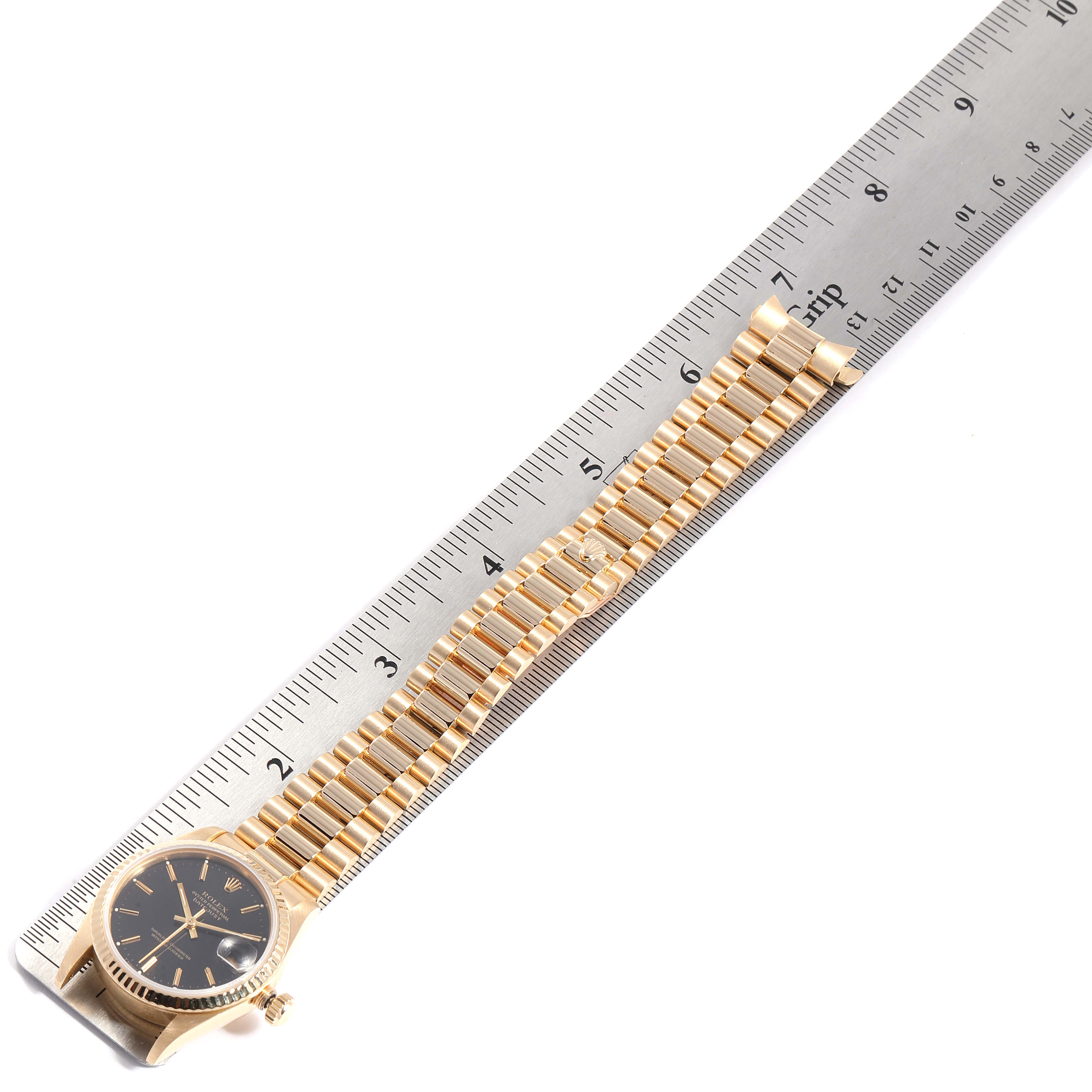 The image shows a Rolex President 68278 Women's Yellow Gold Black Dial 68278 Women's Yellow Gold Black Dial model watch lying flat next to a ruler, displaying the bracelet and partial watch face.