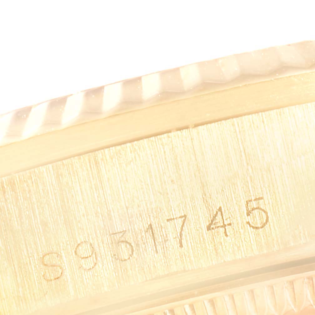 This is a close-up of the serial number area of a Rolex President 68278 Women's Yellow Gold Black Dial 68278 Women's Yellow Gold Black Dial model, showing the case and part of the bezel.