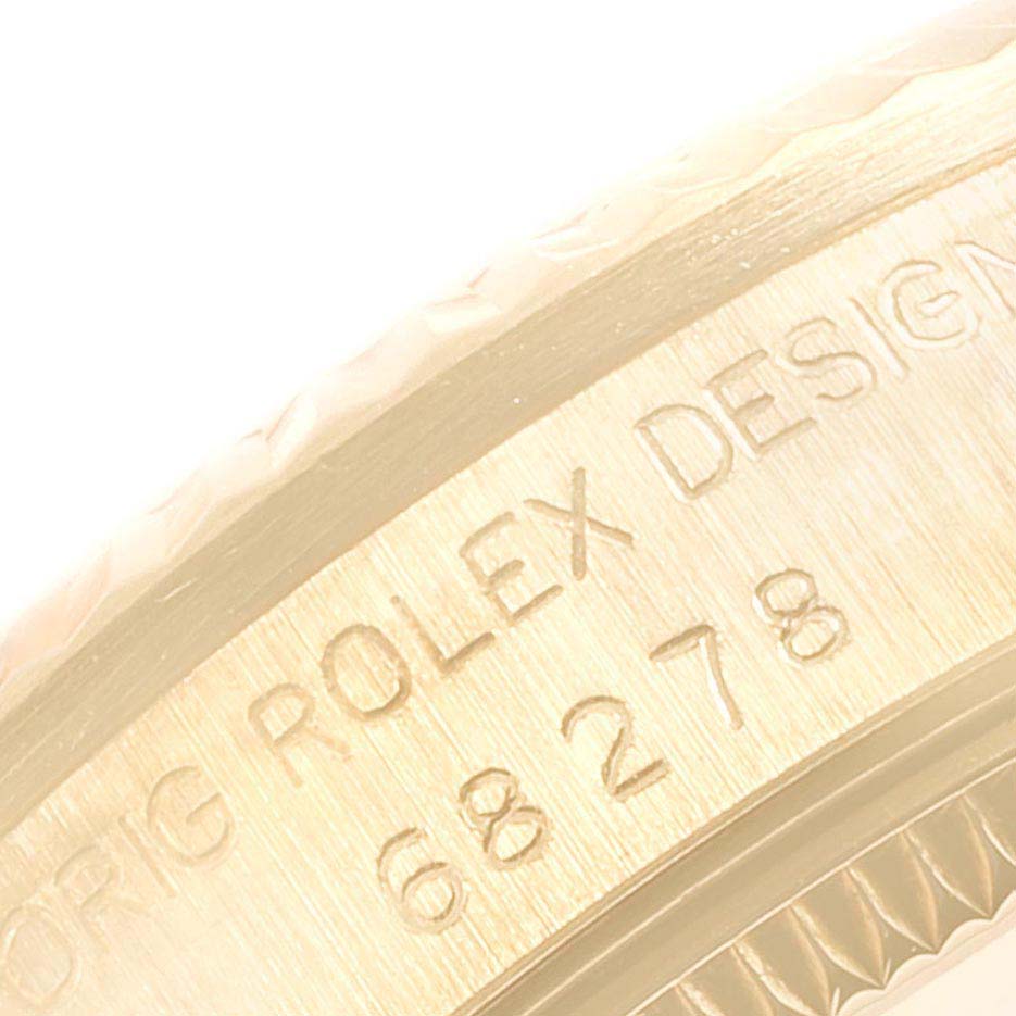 The image shows a close-up of the side case with engraved text on the Rolex President 68278 Women's Yellow Gold Black Dial 68278 Women's Yellow Gold Black Dial watch.