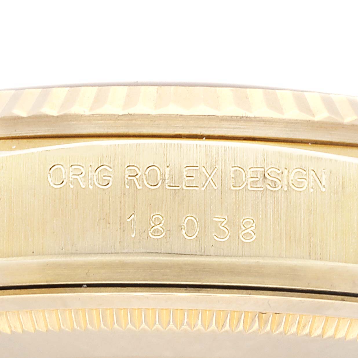 This image shows a close-up of the side engraving on a Rolex President 18038 Men's Yellow Gold Champagne Dial 18038 Men's Yellow Gold Champagne Dial model watch, displaying "ORIG ROLEX DESIGN" and the model number.