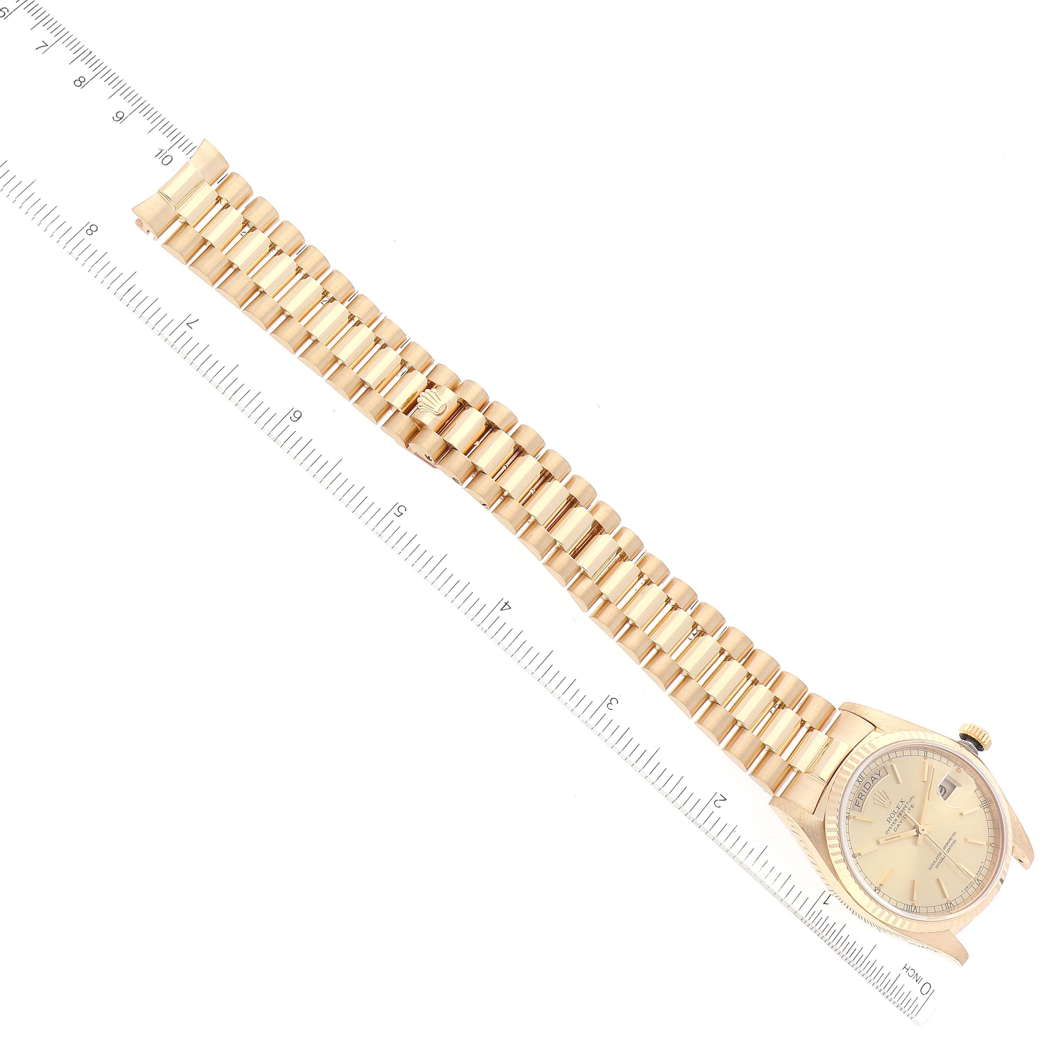 The image shows a Rolex President 18038 Men's Yellow Gold Champagne Dial 18038 Men's Yellow Gold Champagne Dial model watch laying flat with the face and bracelet visible alongside a measuring ruler.