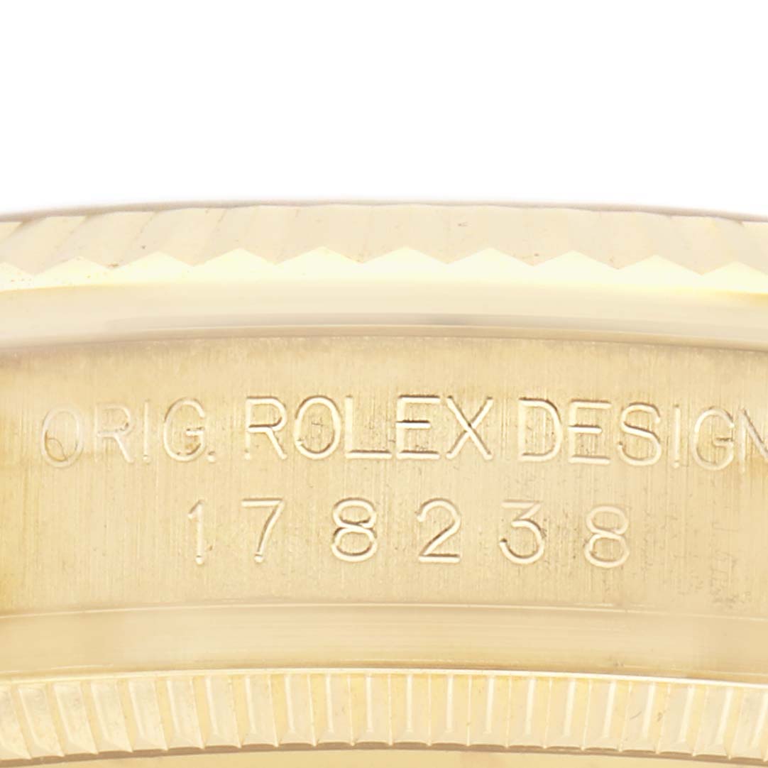 The image shows the side engraving of a Rolex President 178238G Women
s Yellow Gold Champagne Dial 178238G Women
s Yellow Gold Champagne Dial model, highlighting the serial number and "ORIG. ROLEX DESIGN" text.