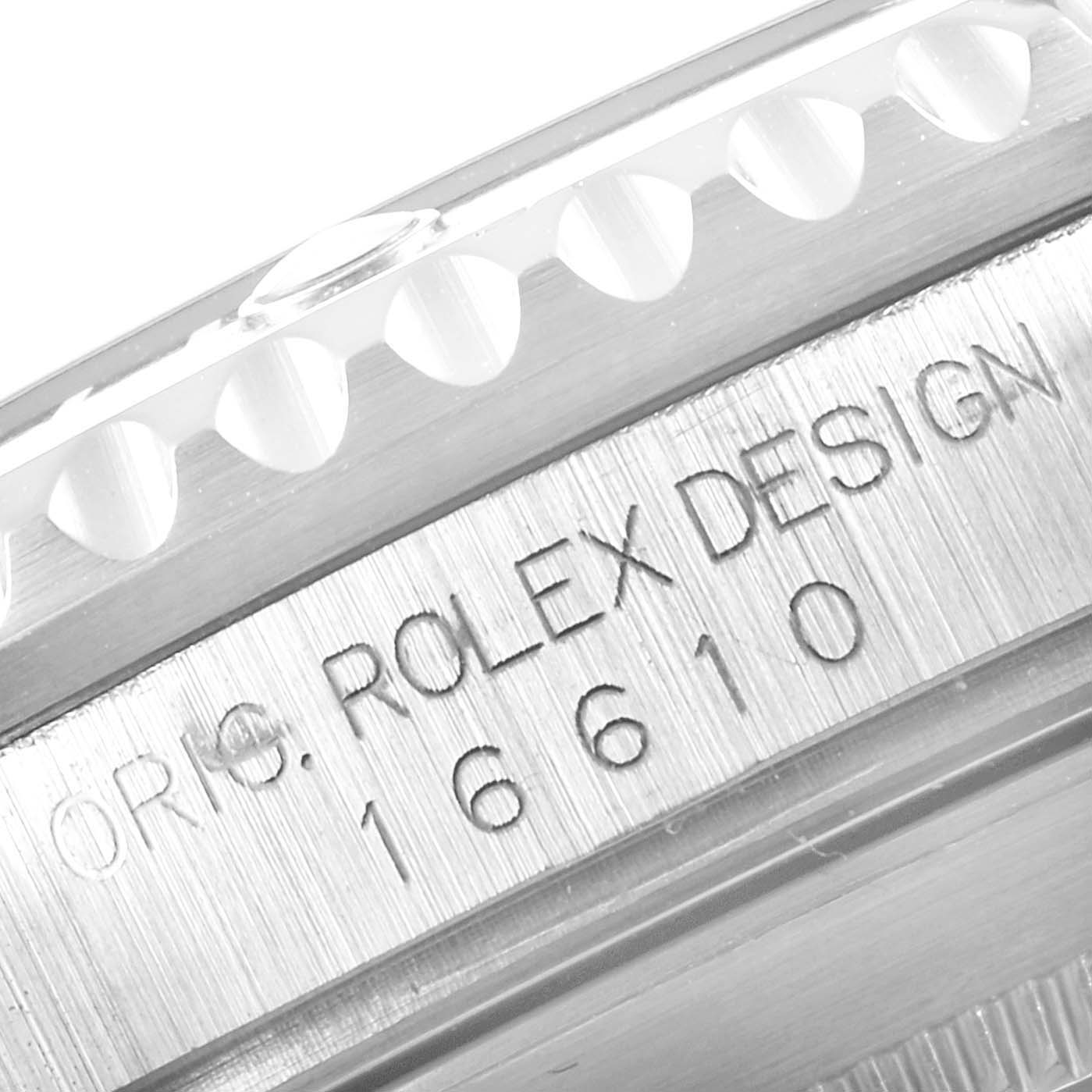 This close-up image shows part of the bezel and engraved serial number on the case side of the Rolex Submariner 16610 Men
s Stainless Steel Black Dial 16610 Men
s Stainless Steel Black Dial watch.