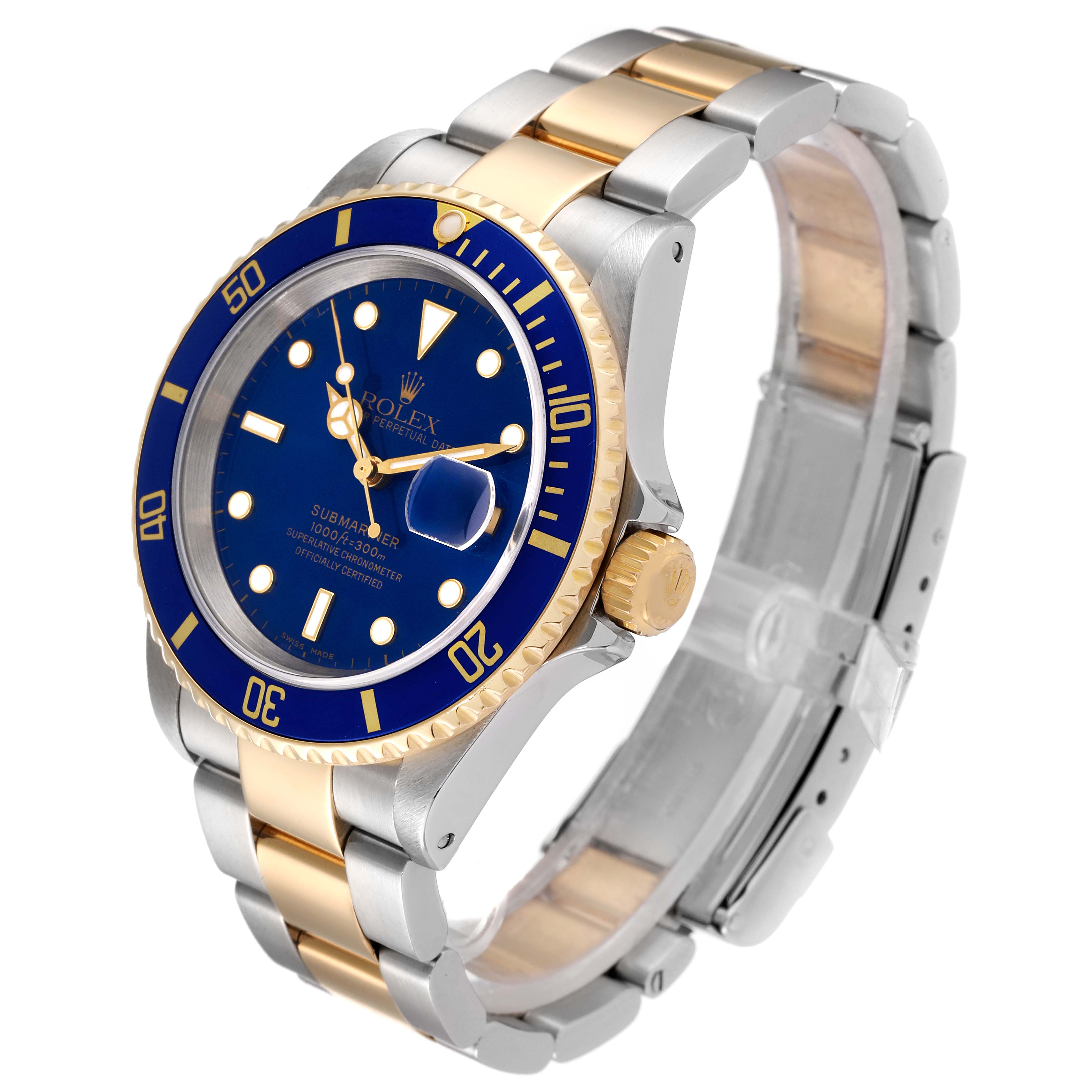 The image shows a Rolex Submariner 16613 Men
s Steel and Gold (two tone) Blue Dial 16613 Men
s Steel and Gold (two tone) Blue Dial watch at a three-quarter angle, highlighting its blue dial, bezel, and two-tone bracelet.