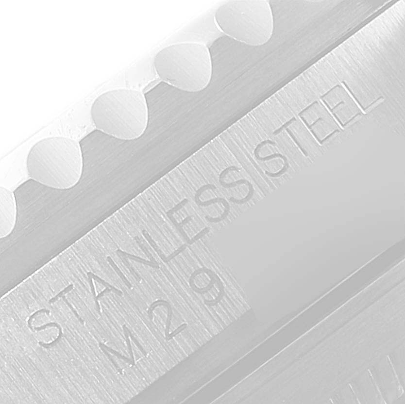 Close-up of the Rolex Submariner 16610LV Men's Stainless Steel Black Dial 16610LV Men's Stainless Steel Black Dial's watch bezel and part of the stainless steel case engraving.