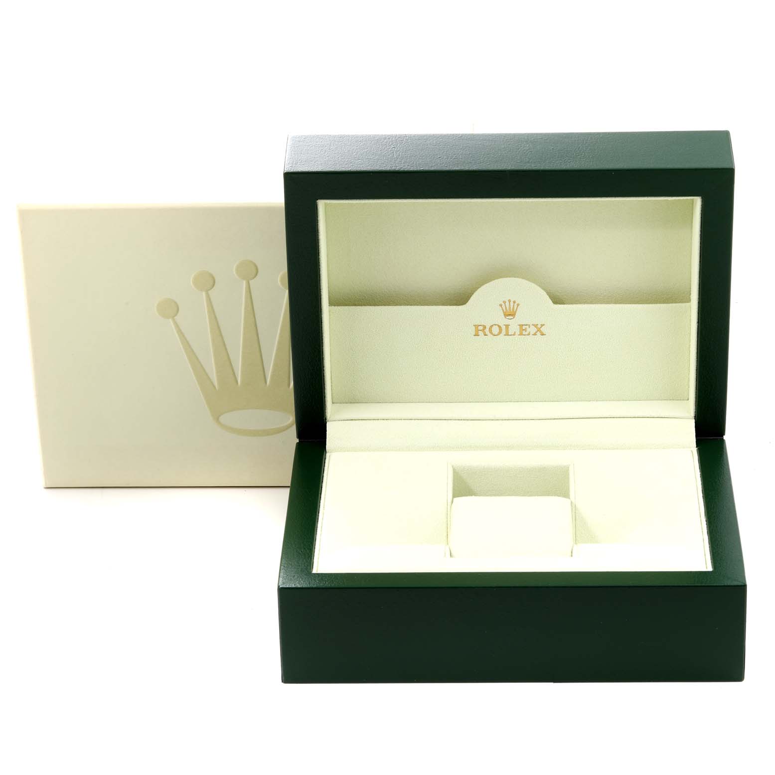 The image shows an open green Rolex box for the Submariner model, revealing its interior.