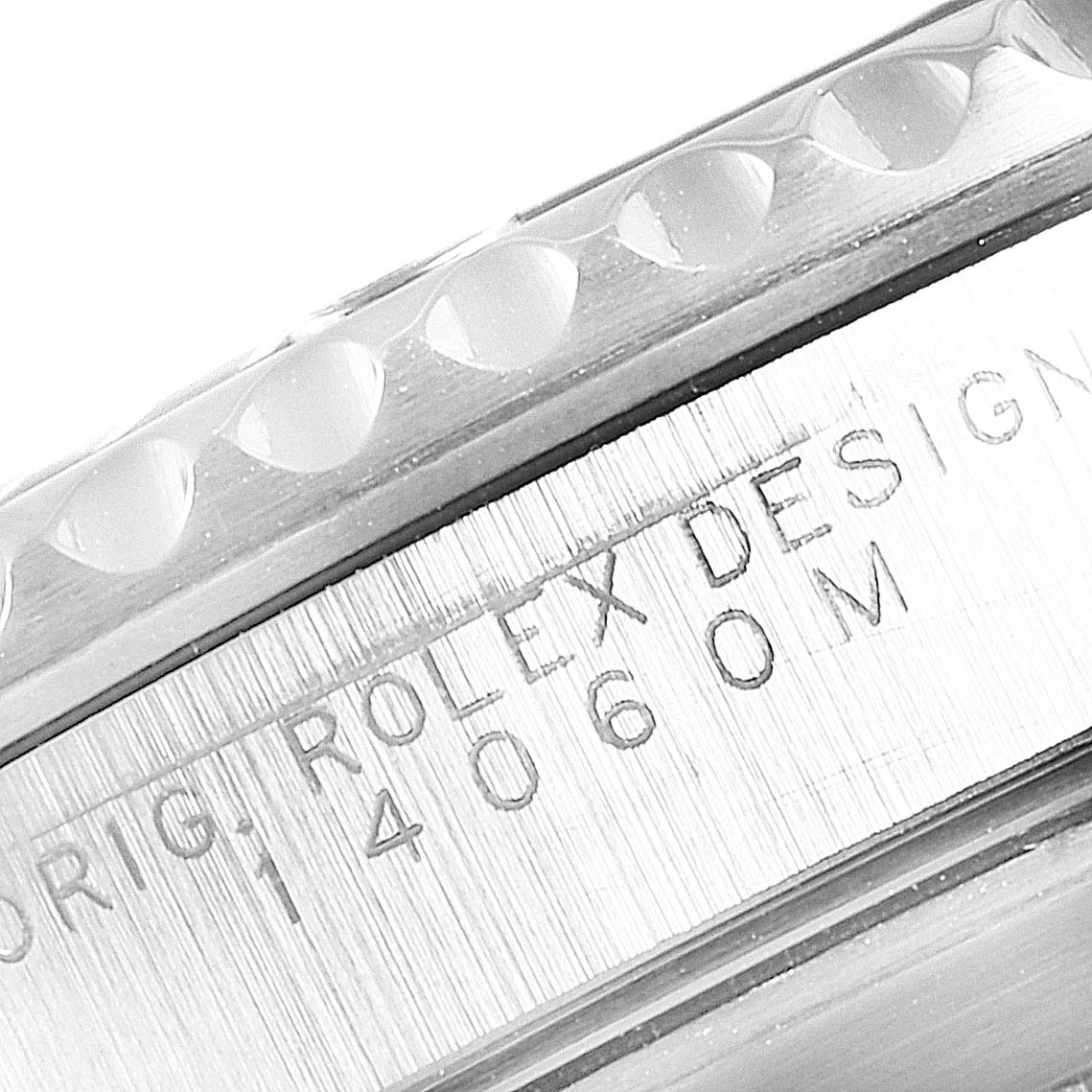 This image shows a close-up of the Rolex Submariner 14060M Men
s Stainless Steel Black Dial 14060M Men
s Stainless Steel Black Dial
s bezel and case, with the engraved model information visible.