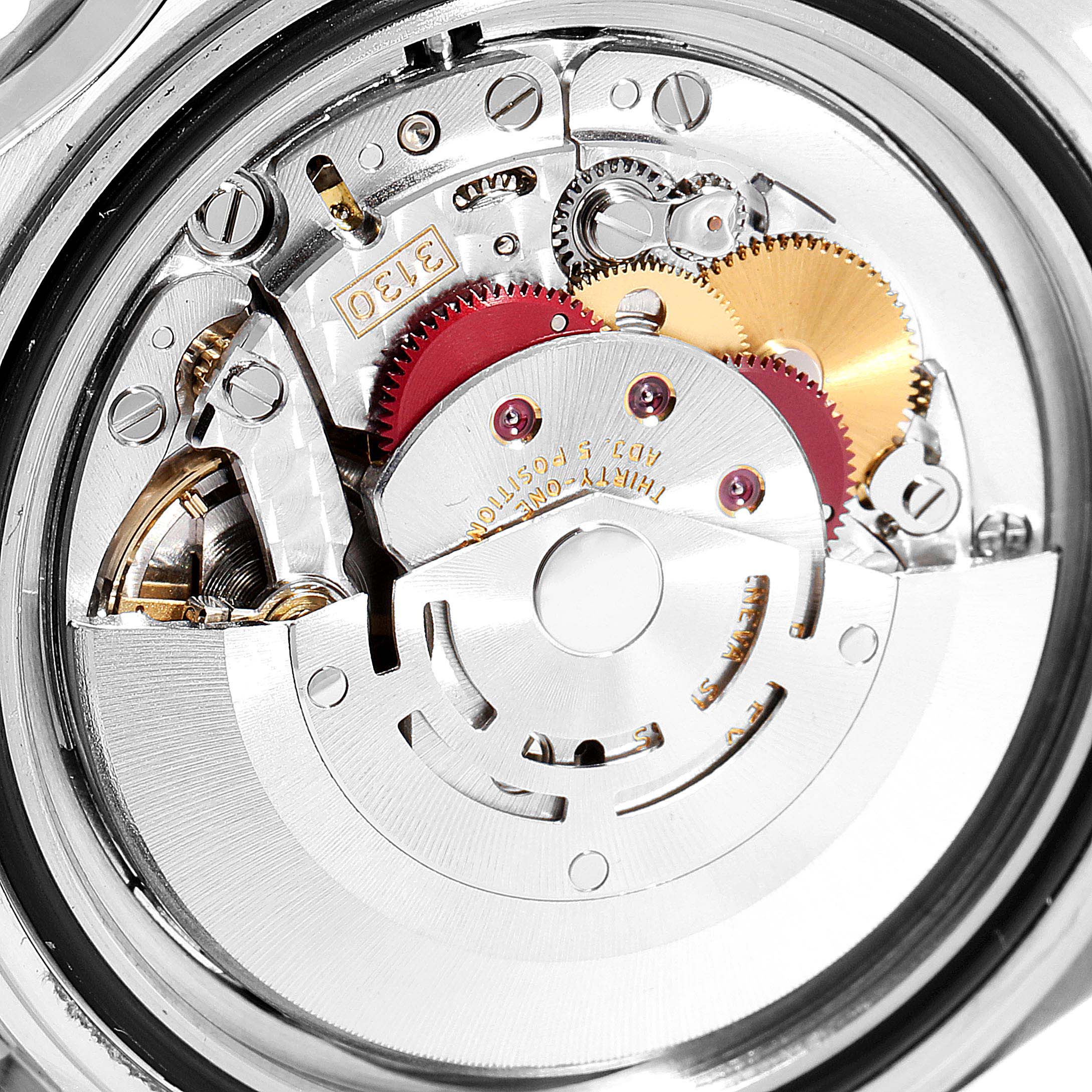 This is an image of the movement mechanism of a Rolex Submariner 14060M Men
s Stainless Steel Black Dial 14060M Men
s Stainless Steel Black Dial watch, showing gears and intricate components.