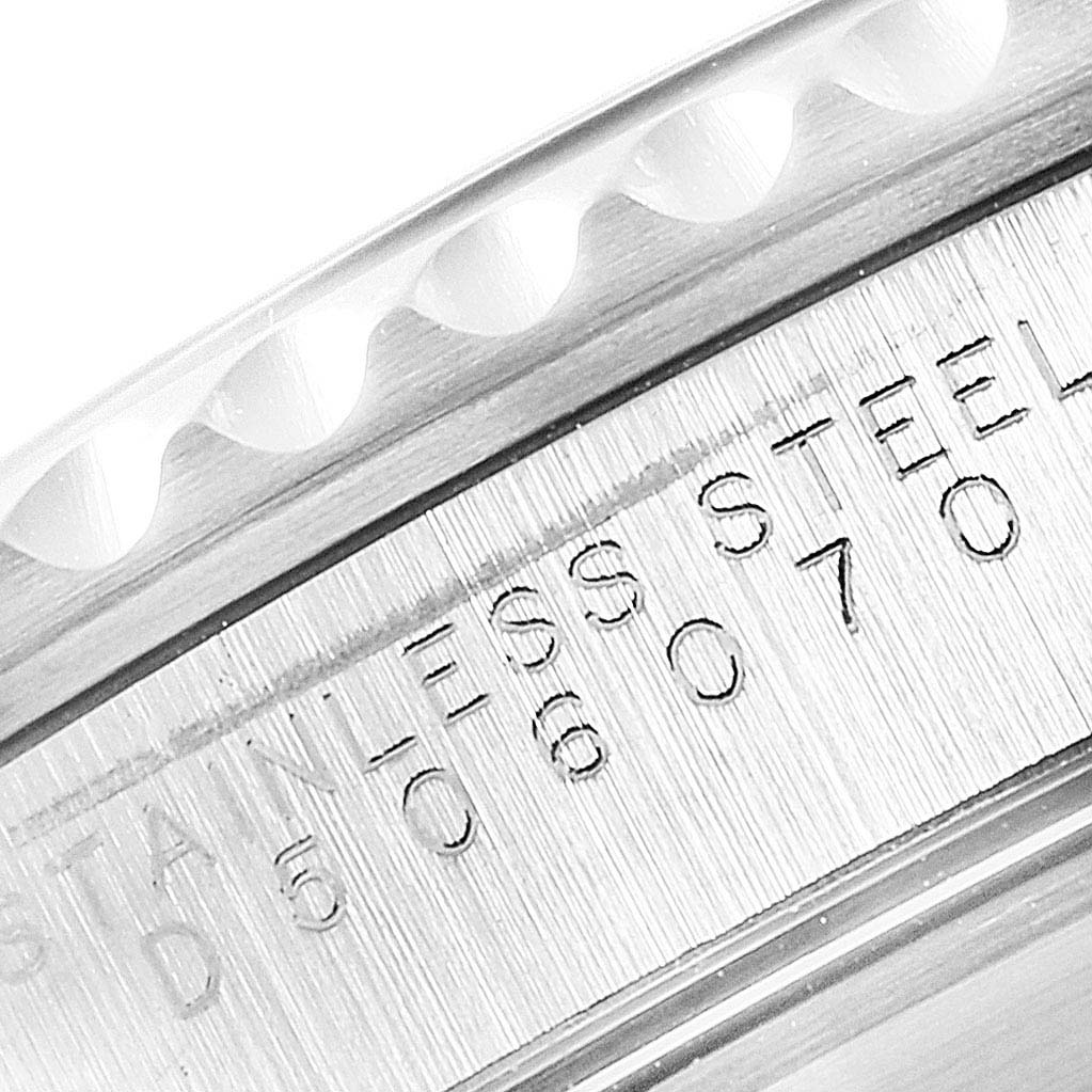 This close-up image shows the engraving on the stainless steel bezel edge of a Rolex Submariner 14060M Men
s Stainless Steel Black Dial 14060M Men
s Stainless Steel Black Dial watch.