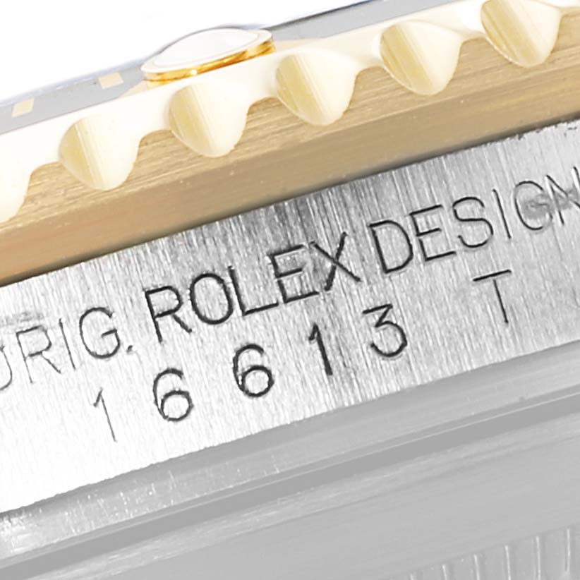 This close-up image shows the side engraving of a Rolex Submariner 16613 Men's Steel and Gold (two tone) Black Dial 16613 Men's Steel and Gold (two tone) Black Dial watch with the model number 16613T.