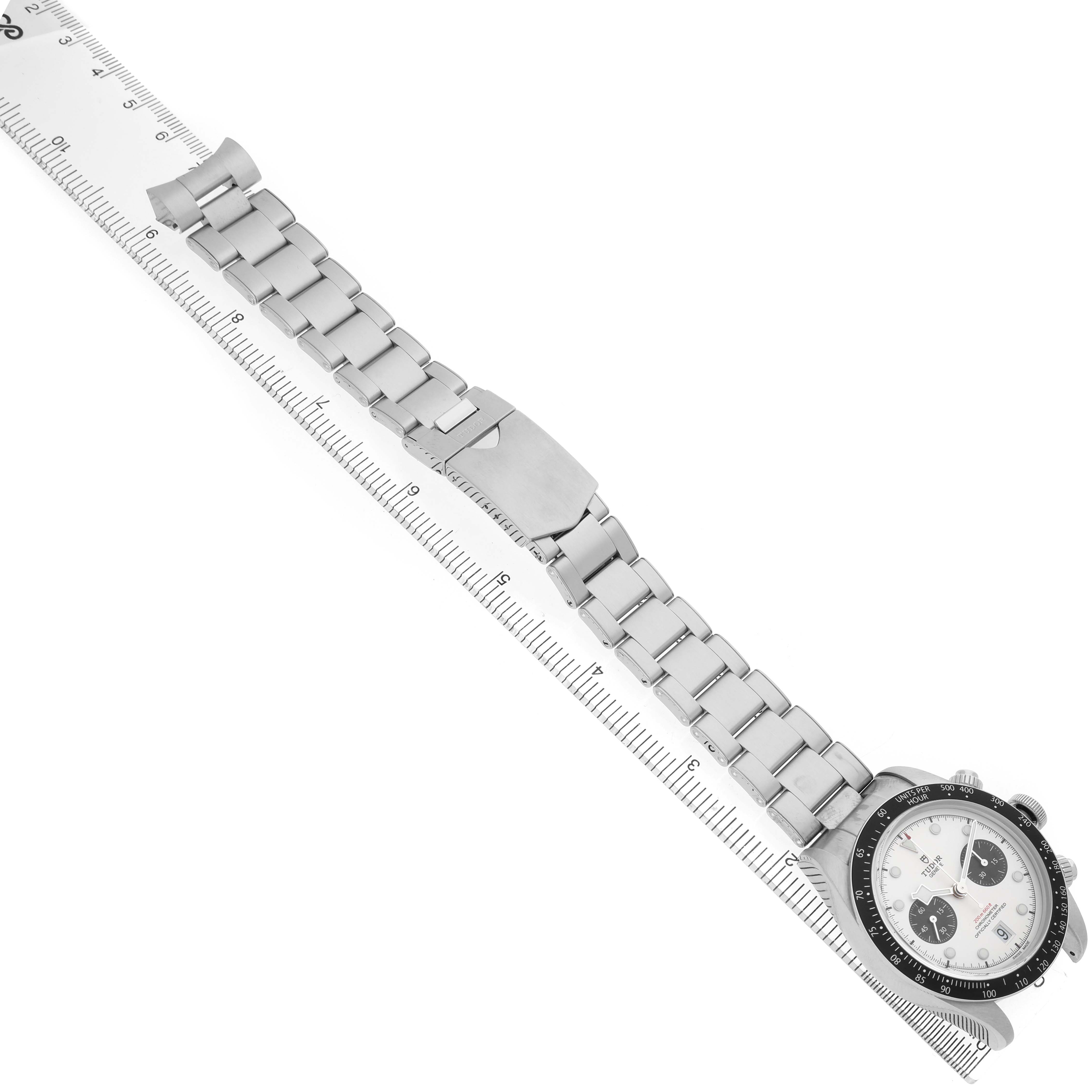 The Tudor Heritage Black Bay M79360N-0012 Men's Stainless Steel Silver Dial watch is shown diagonally, displaying the full bracelet and watch face next to a ruler for scale.