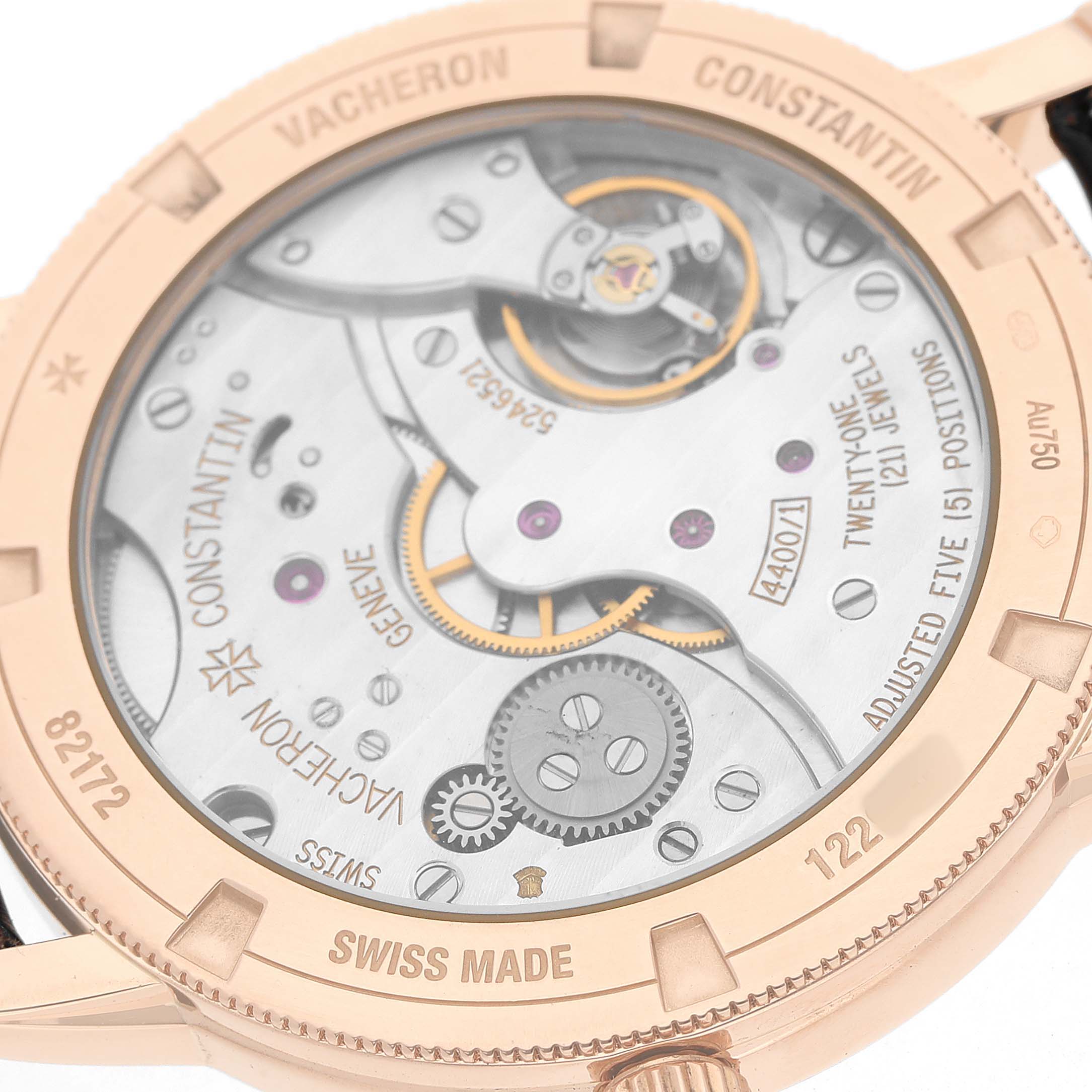 The image shows the back of a Vacheron Constantin Traditionnelle 82172 Men's Rose Gold Silver Dial watch, highlighting its intricate mechanical movement and engraving details.
