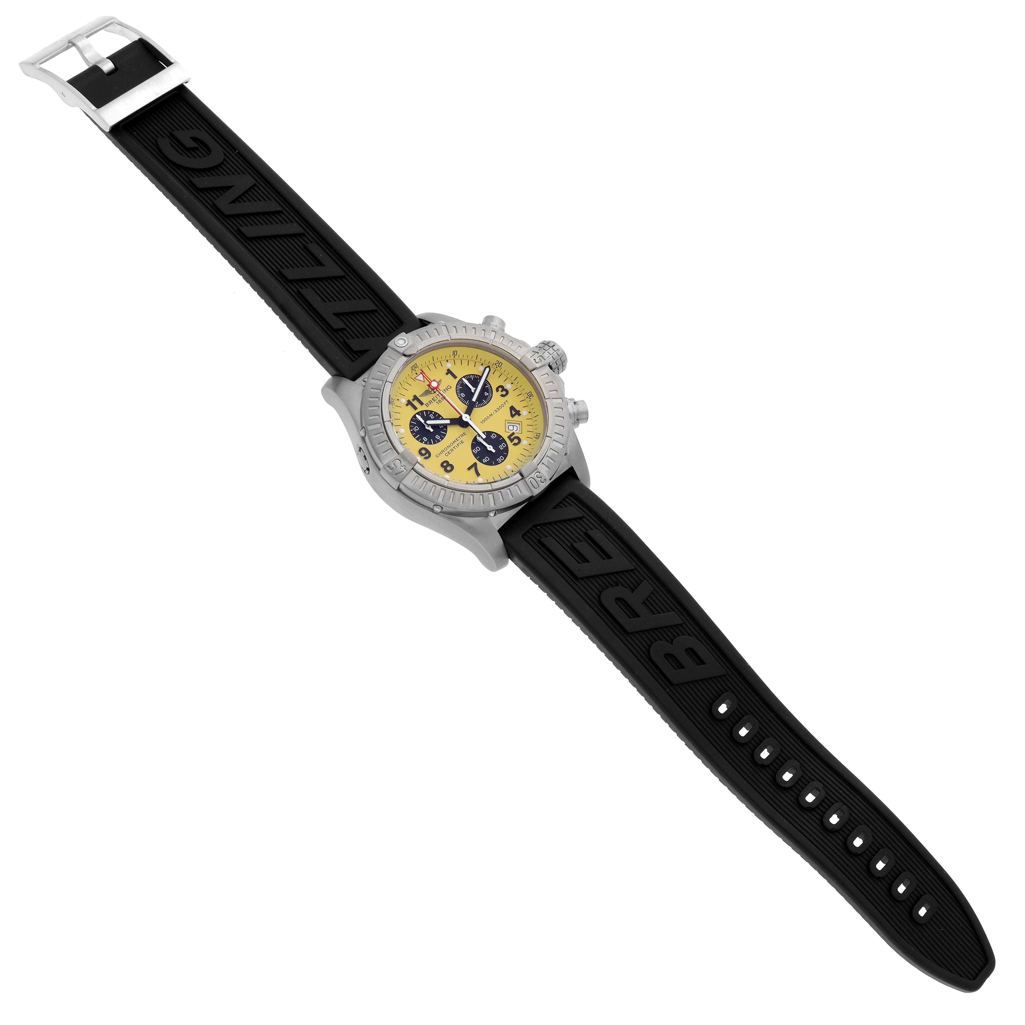 The Breitling Avenger E73360 Men's Titanium Yellow Dial E73360 Men's Titanium Yellow Dial watch is shown from a top-down angle, featuring a yellow dial, black rubber strap, and chronograph sub-dials.