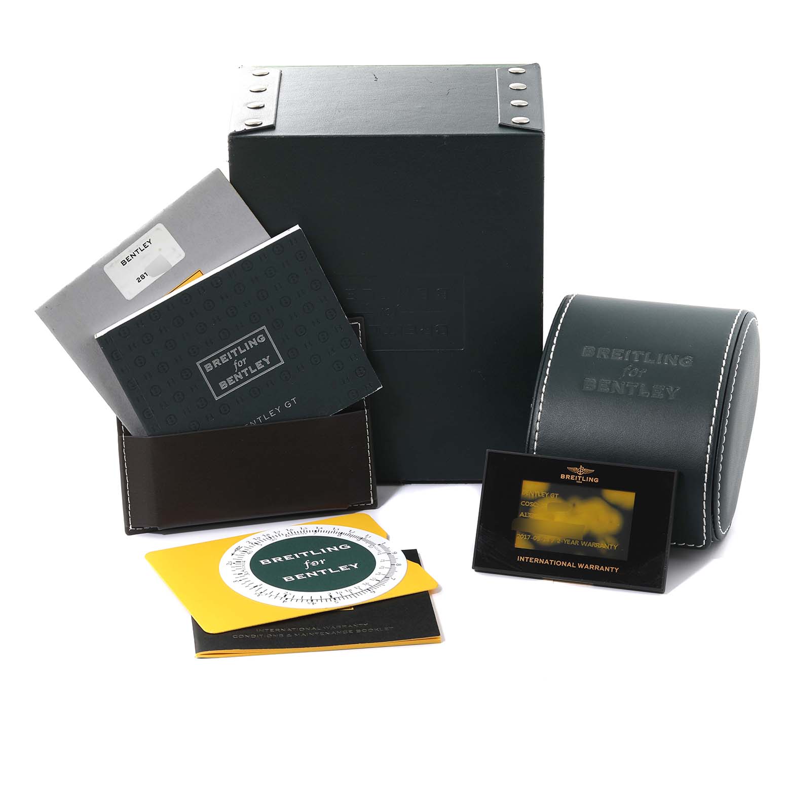 The image shows the packaging, manuals, warranty card, and case accessories for a Bentley model by Breitling.