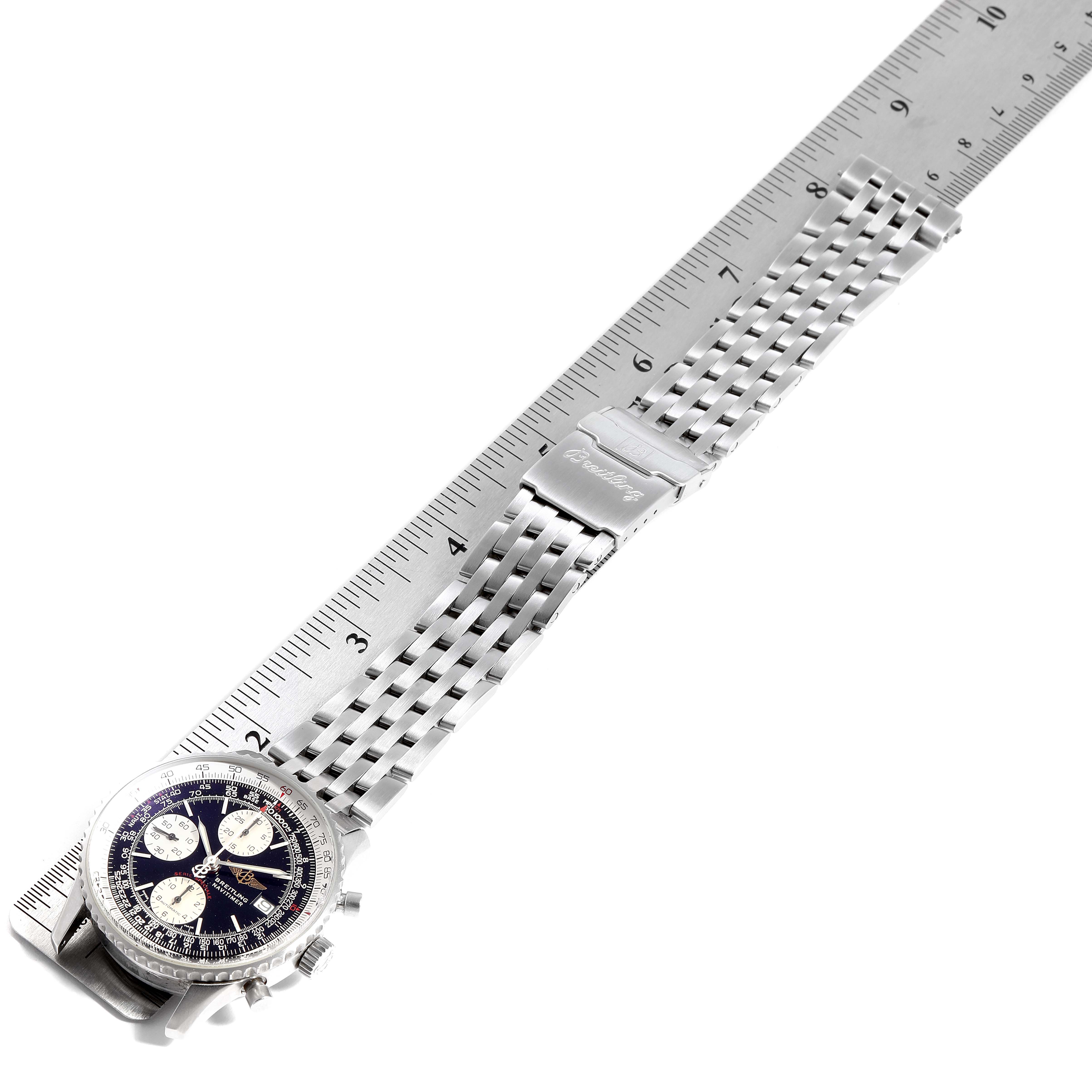 A Breitling Navitimer A13330 Men's Stainless Steel Black Dial A13330 Men's Stainless Steel Black Dial watch is shown from a top-down angle, displaying its face and metal bracelet measured against a ruler.