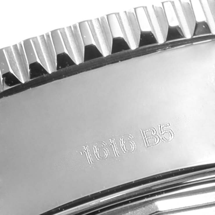 The image shows a close-up of the bezel and part of the casing of a Breitling Superocean A13311 Men's Stainless Steel Blue Dial A13311 Men's Stainless Steel Blue Dial watch.