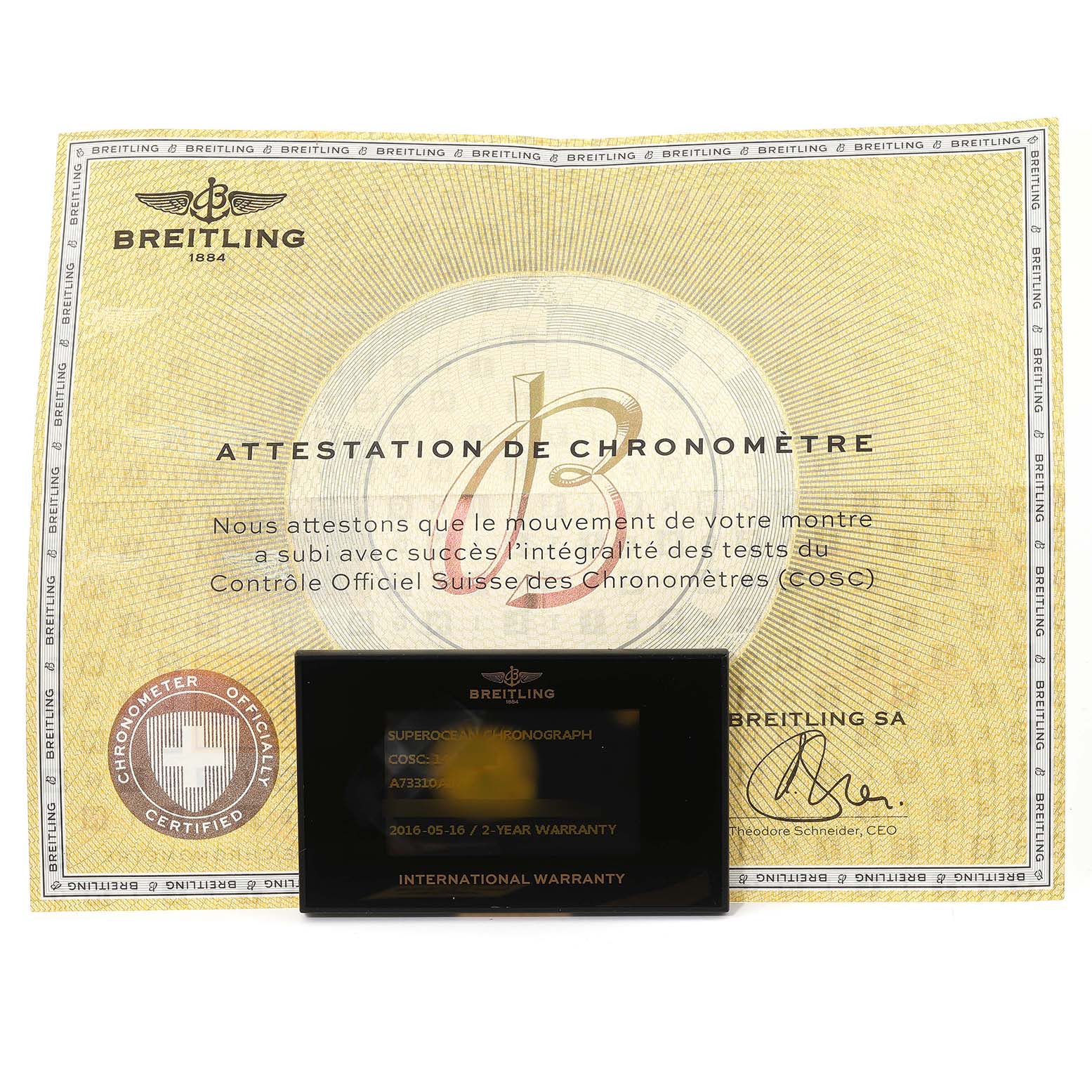 The image shows a Breitling Superocean A73310 Men's Stainless Steel Black Dial A73310 Men's Stainless Steel Black Dial certificate of chronometer and international warranty card on flat lay.