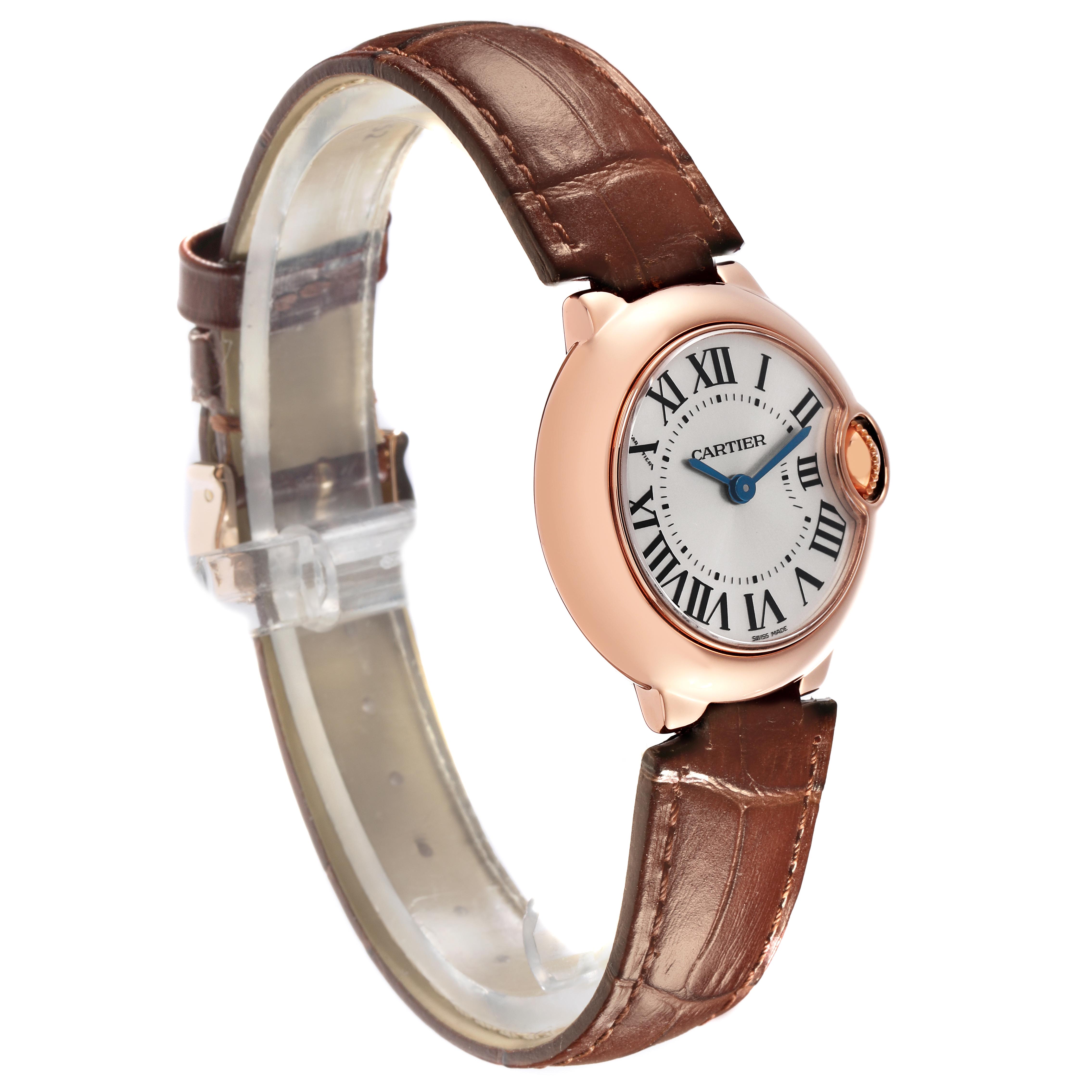 The Cartier Ballon Bleu W6900256 Women
s Rose Gold Silver Dial W6900256 Women
s Rose Gold Silver Dial watch is shown at a side angle, highlighting its round case, leather strap, and Roman numeral dial.