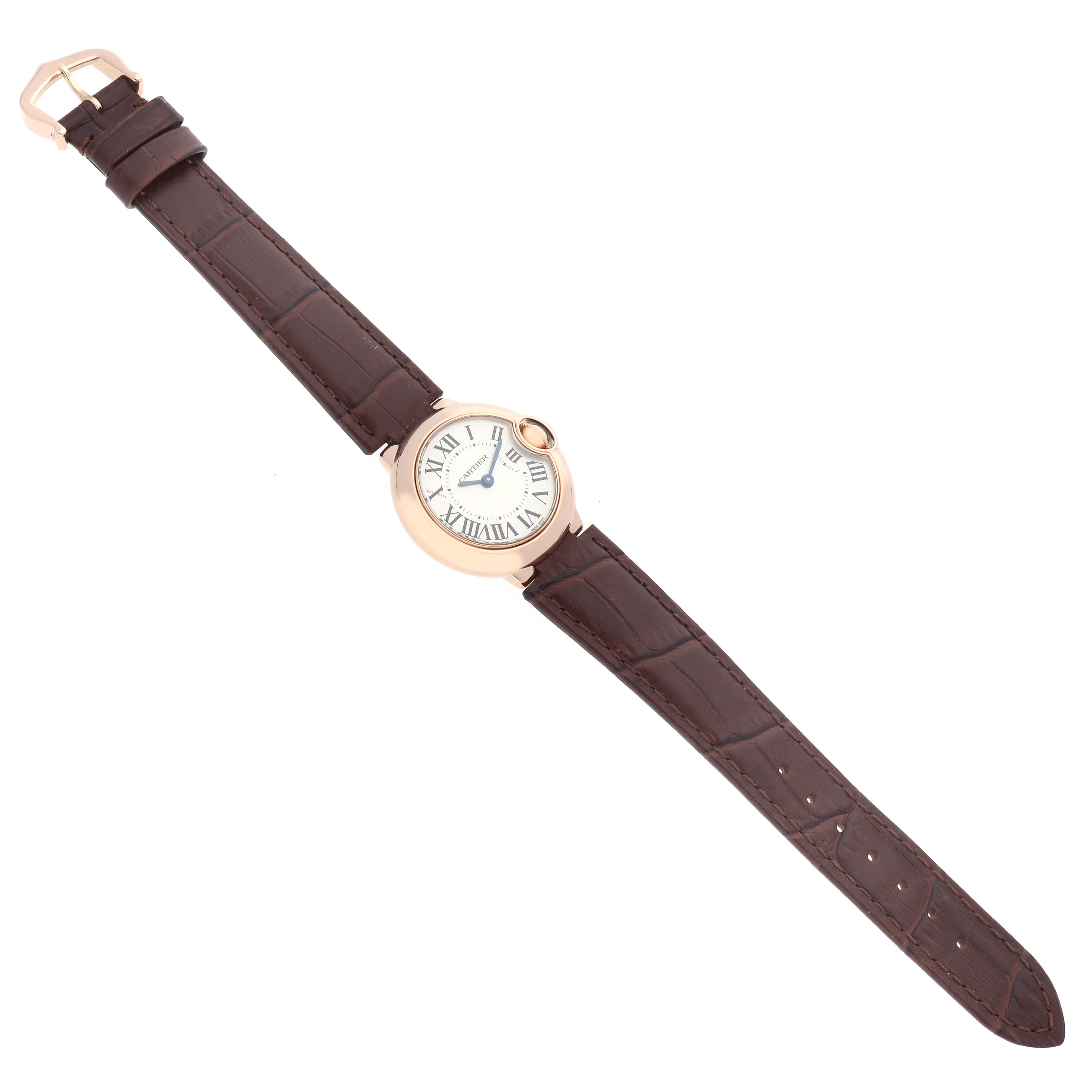 The Cartier Ballon Bleu W6900256 Women
s Rose Gold Silver Dial W6900256 Women
s Rose Gold Silver Dial watch is shown laid flat, displaying the full face, leather strap, and clasp.