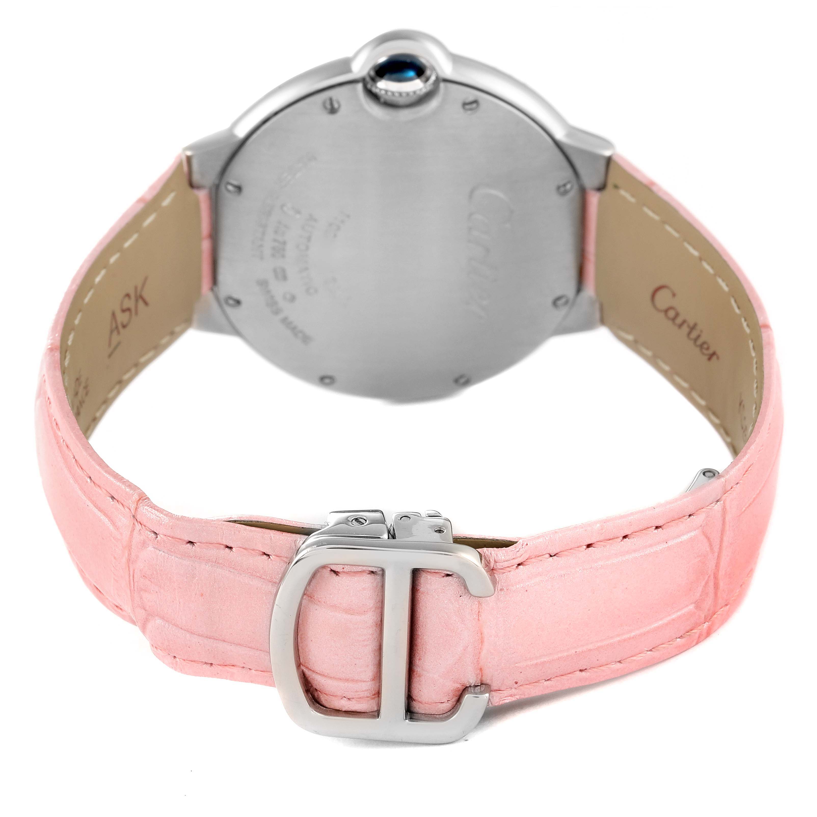 The image shows the back of a Ballon Bleu by Cartier watch, highlighting the case back, pink leather strap, and buckle.