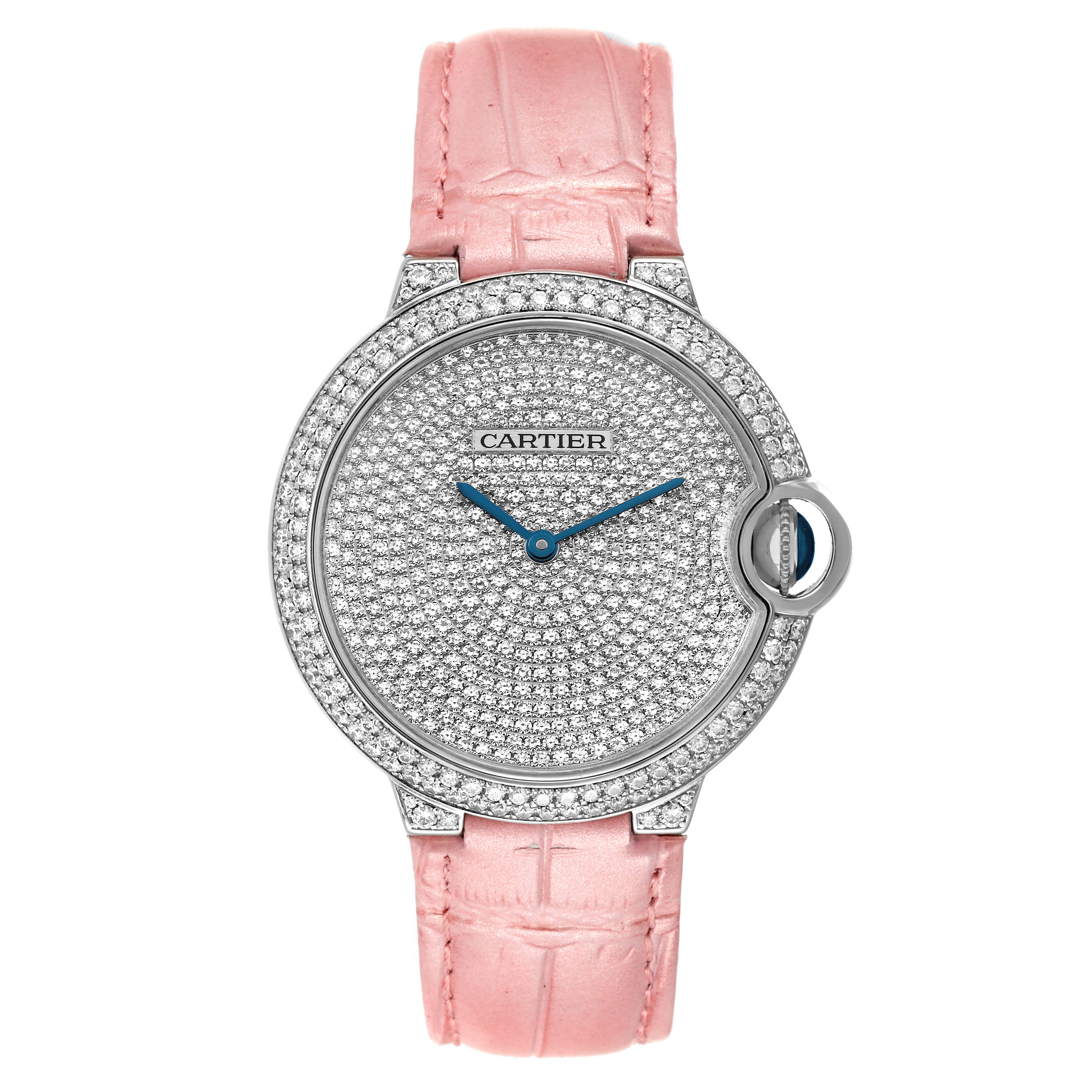 The image shows a front view of a Cartier Ballon Bleu WE902042 Women
s White Gold Silver Dial WE902042 Women
s White Gold Silver Dial watch with a pink strap and diamond-encrusted face and bezel.