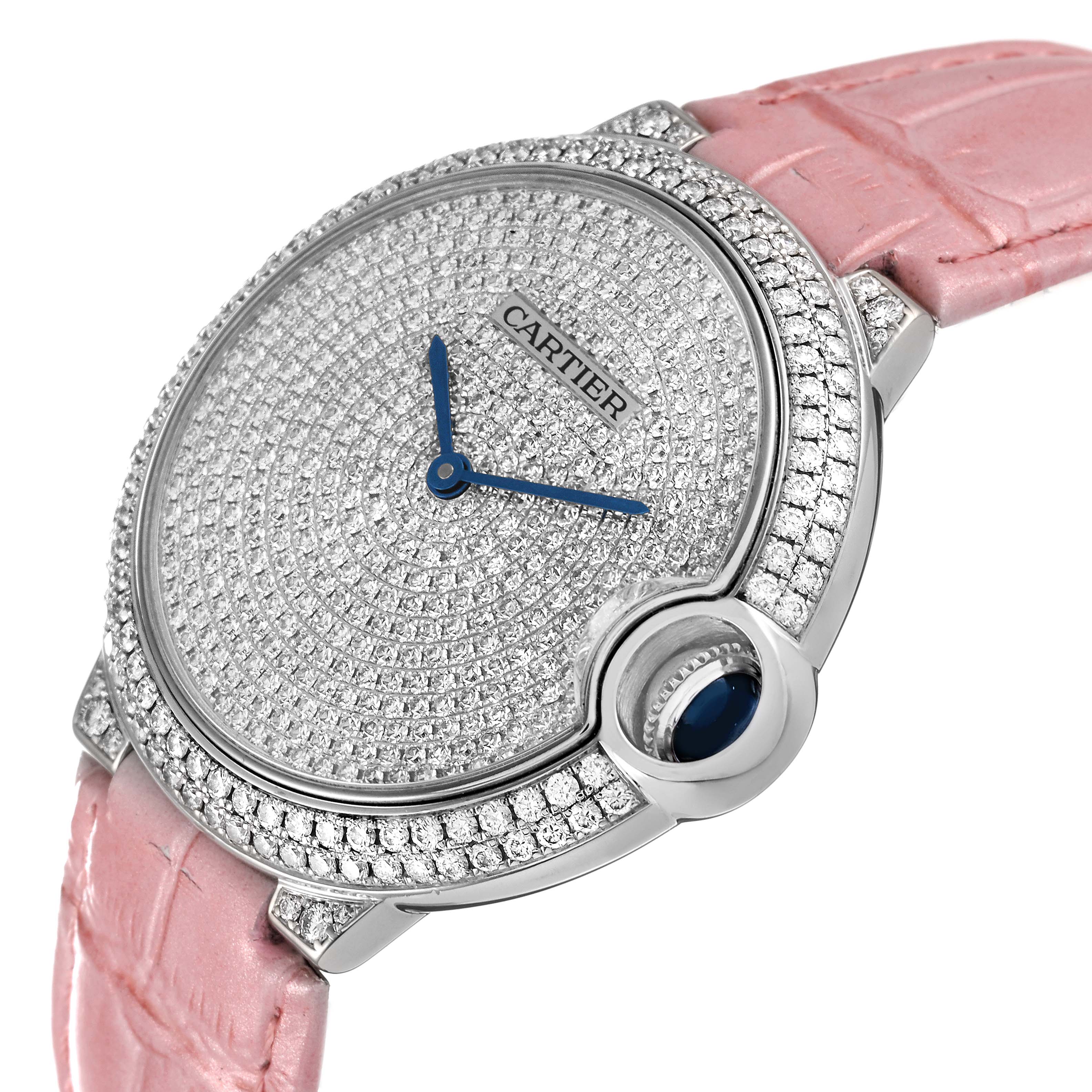 This Cartier Ballon Bleu WE902042 Women
s White Gold Silver Dial WE902042 Women
s White Gold Silver Dial watch is shown at an angle revealing its diamond-encrusted face and pink strap.