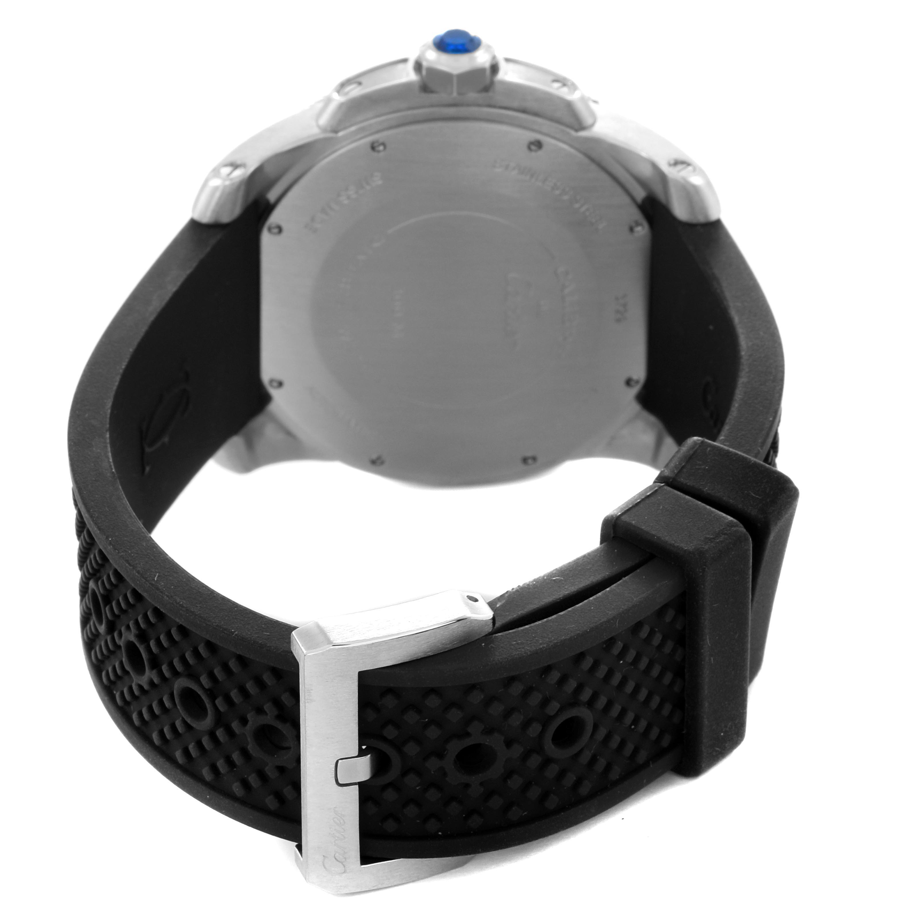 The image shows the back of the Calibre de Cartier watch by Cartier, highlighting the case back, crown, and rubber strap.