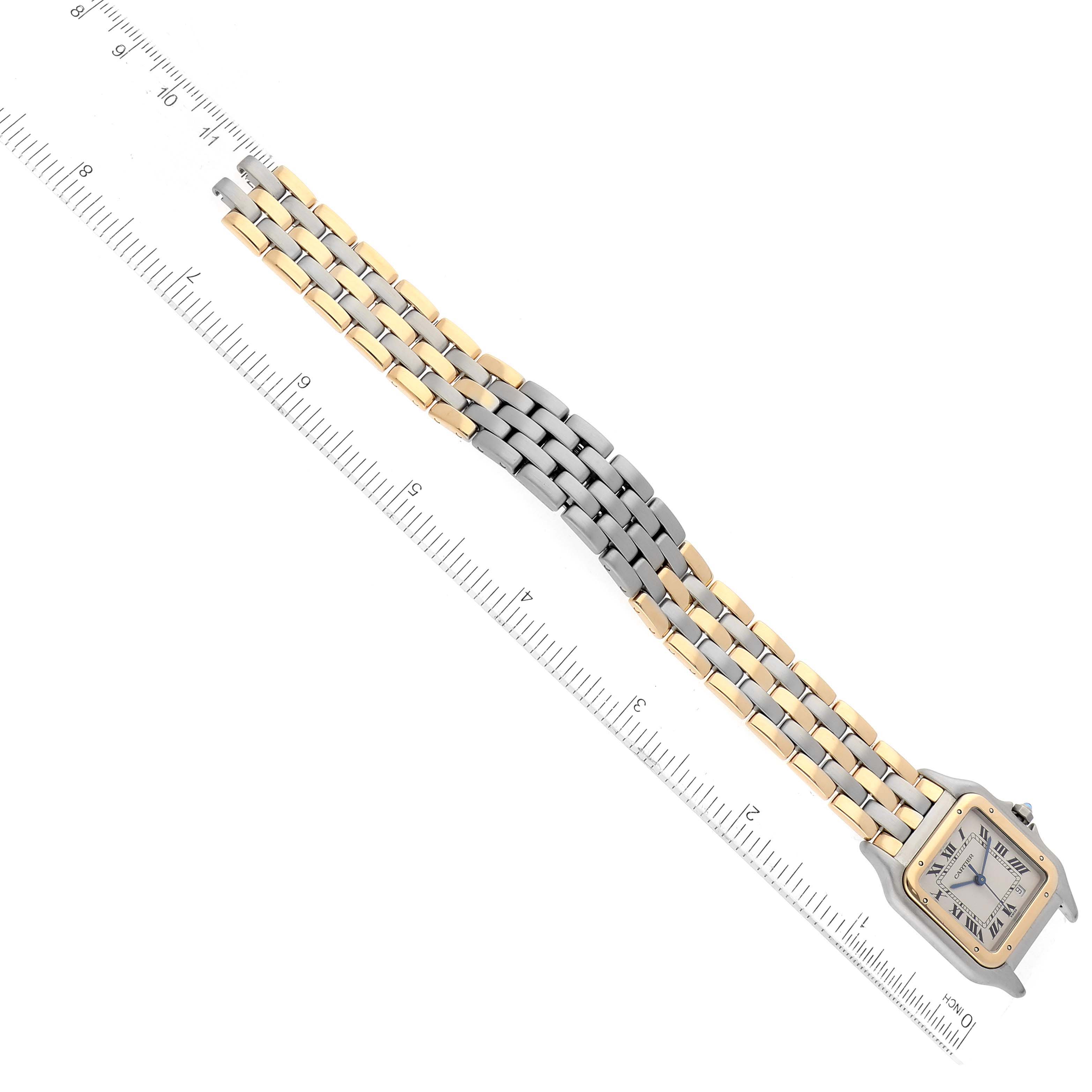 The Cartier Panthere W25028B8 Women's Steel and Gold (two tone) Silver Dial W25028B8 Women's Steel and Gold (two tone) Silver Dial watch is shown from an overhead angle, highlighting its dual-tone bracelet and square face beside a ruler.