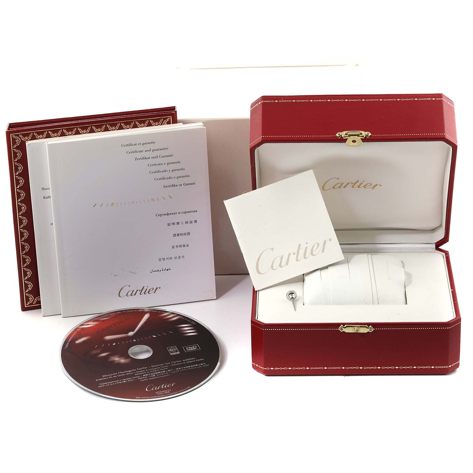The image shows the packaging, manuals, a DVD, and a tool for the Cartier Pasha W31089M7 Men
s Stainless Steel Silver Dial W31089M7 Men
s Stainless Steel Silver Dial watch, including its red box and warranty cards.