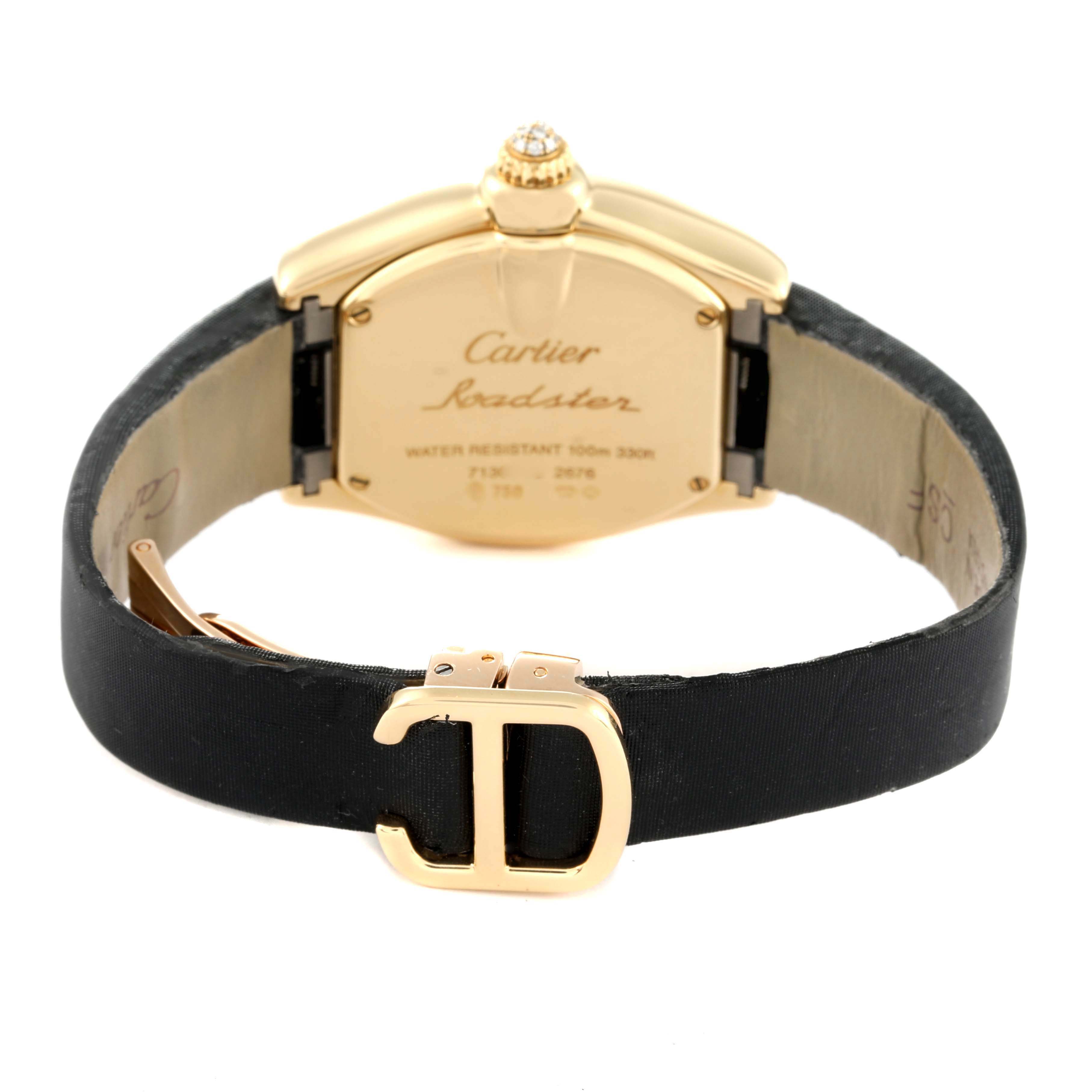The Cartier Roadster WE500160 Women
s Yellow Gold Silver Dial WE500160 Women
s Yellow Gold Silver Dial watch is shown from the back, highlighting the clasp and the engraved case back details.
