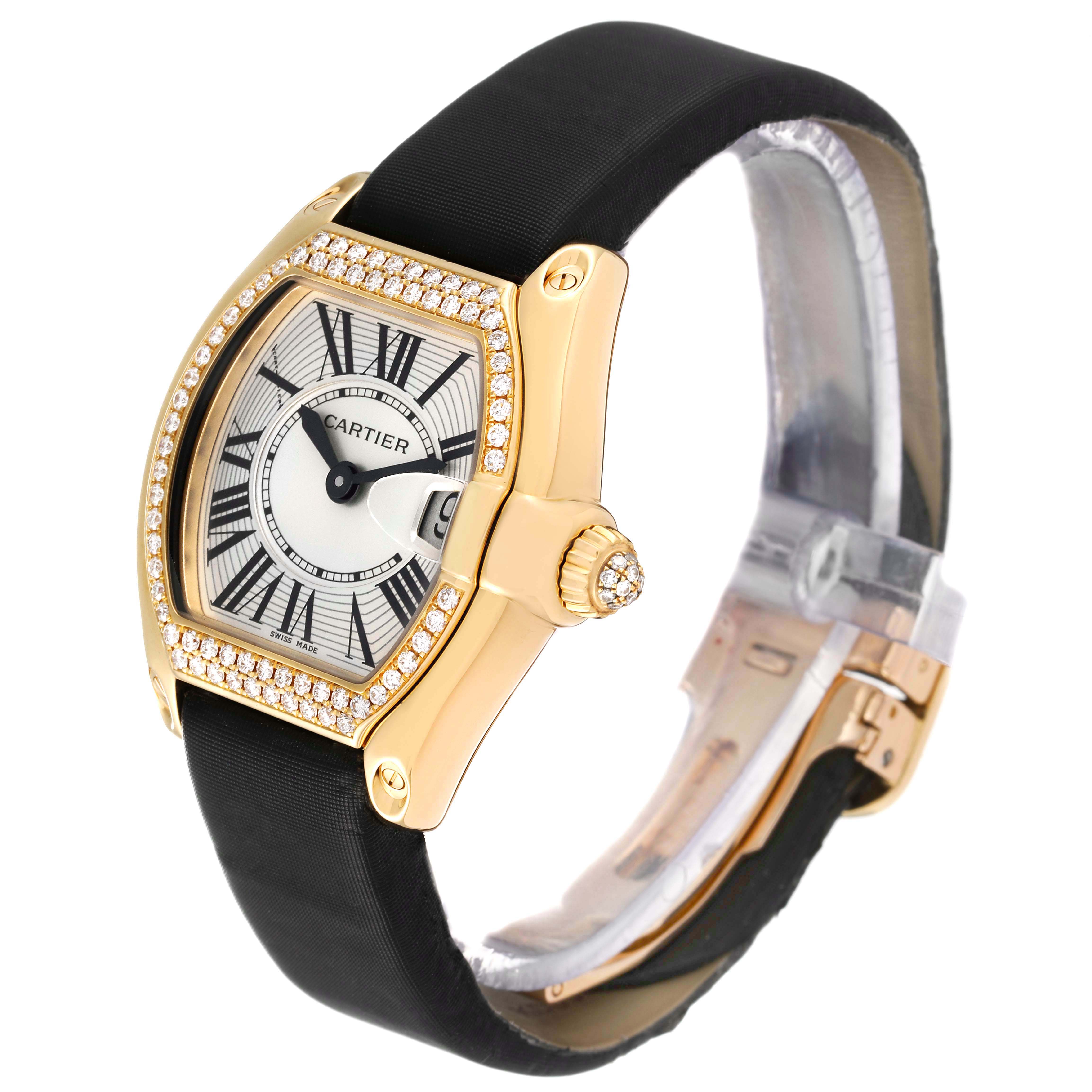 The Cartier Roadster WE500160 Women
s Yellow Gold Silver Dial WE500160 Women
s Yellow Gold Silver Dial watch is shown at an angled side view, highlighting the watch face, gold and diamond-studded bezel, and black strap.