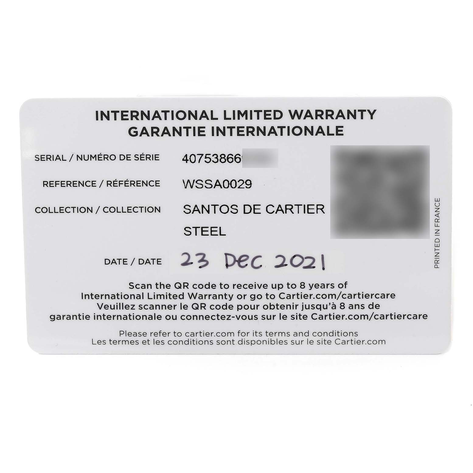 This image shows the international limited warranty card for the Santos de Cartier steel model from Cartier, dated 23 Dec 2021.