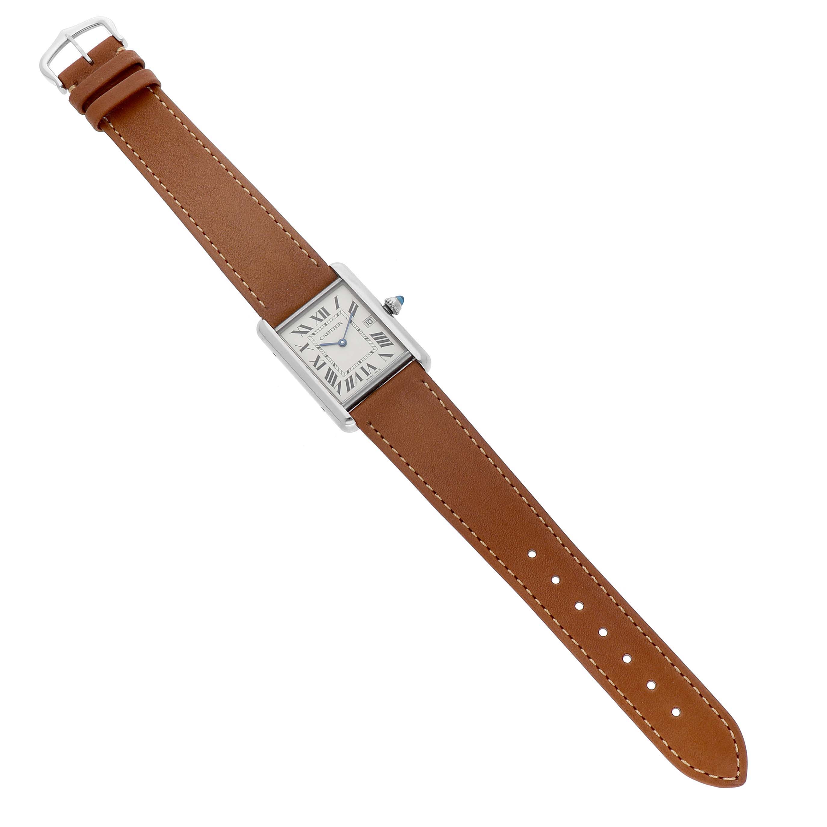 The Cartier Tank Louis W1540956 Men's White Gold Silver Dial watch is shown from a top-down angle, displaying the leather strap and rectangular face.