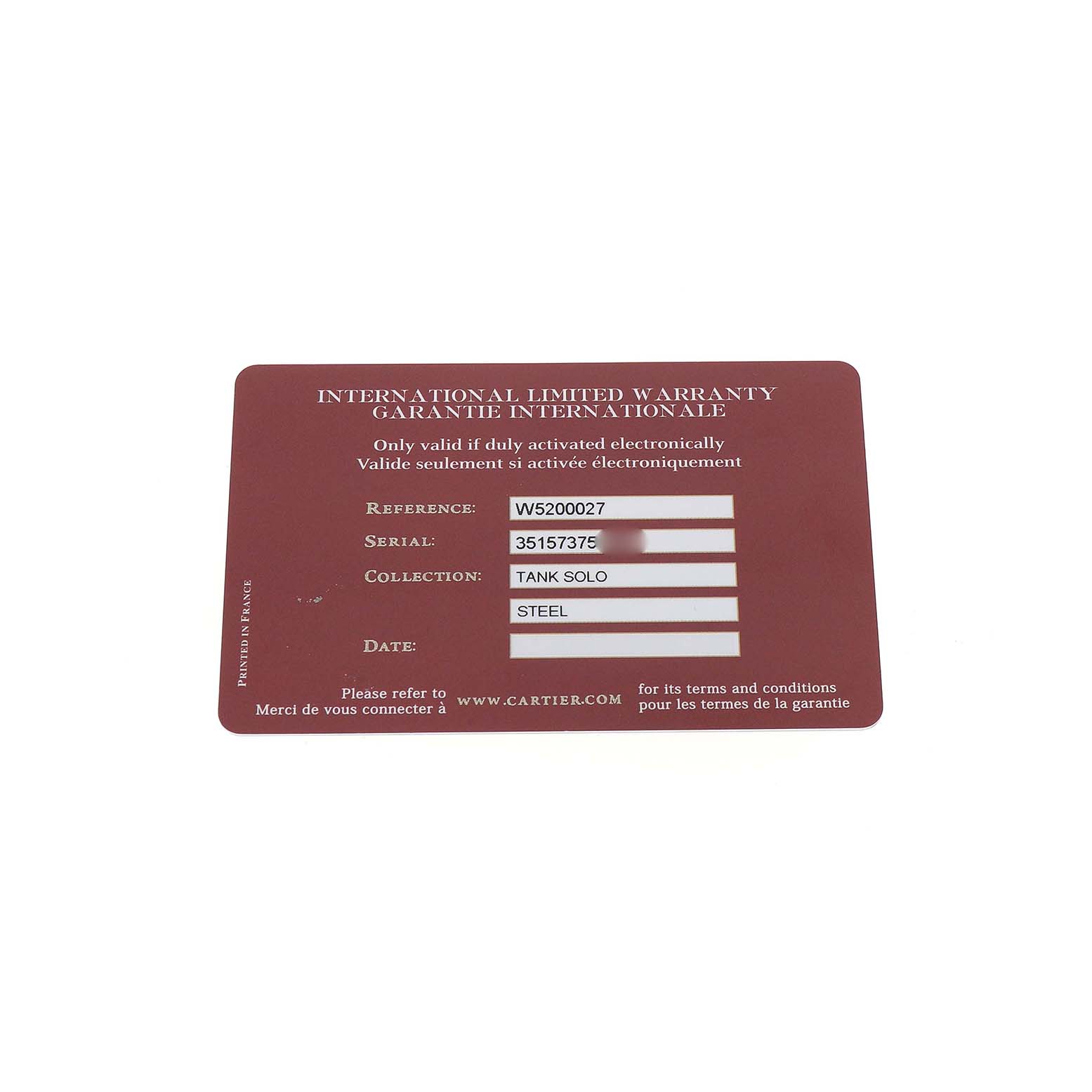 The image shows an international warranty card for the Cartier Tank Solo W5200027 Men's Stainless Steel Silver Dial model, viewed from the top.