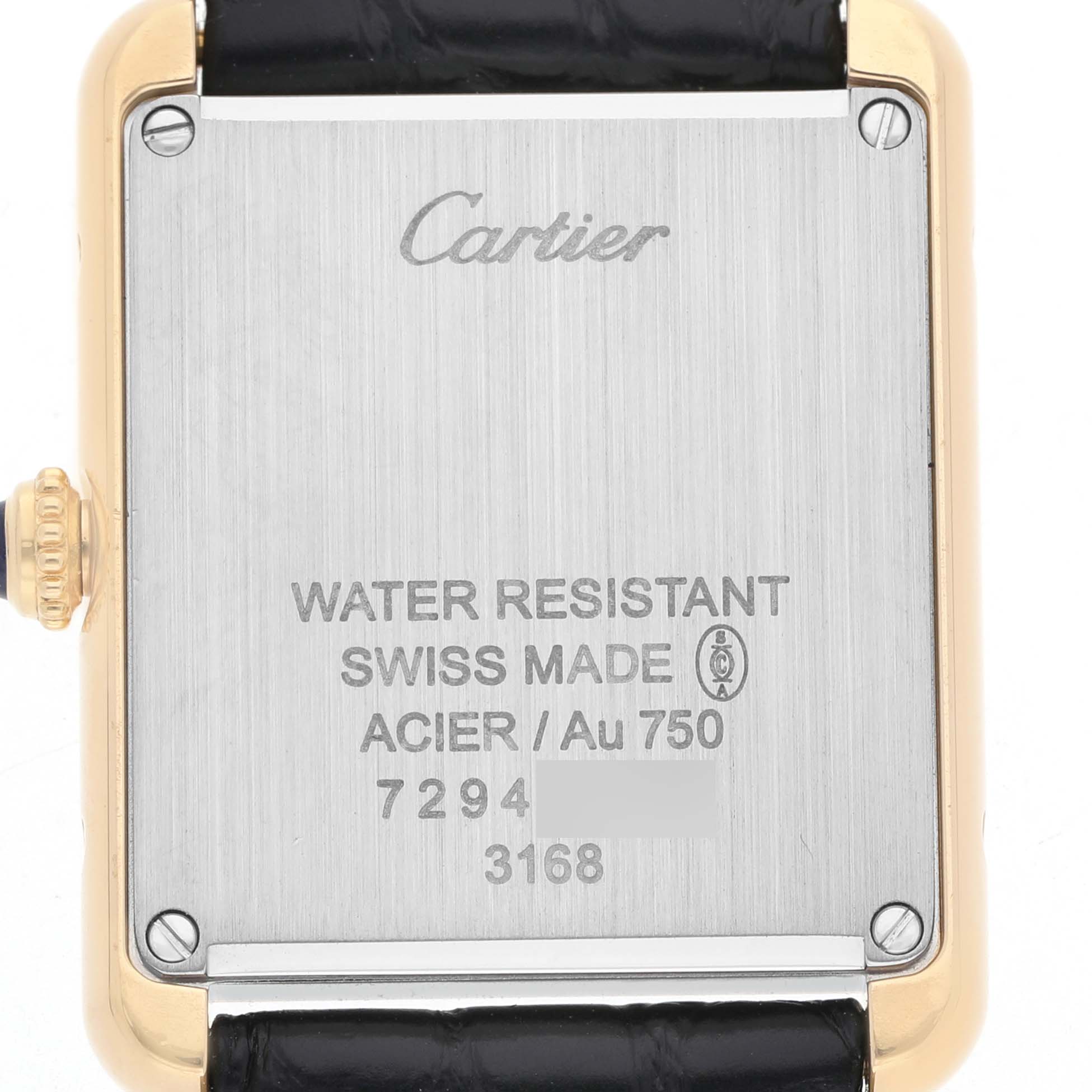 The image shows the back of a Cartier Tank Solo W5200002 Women's Yellow Gold Silver Dial watch, highlighting its metal case and engraved details.