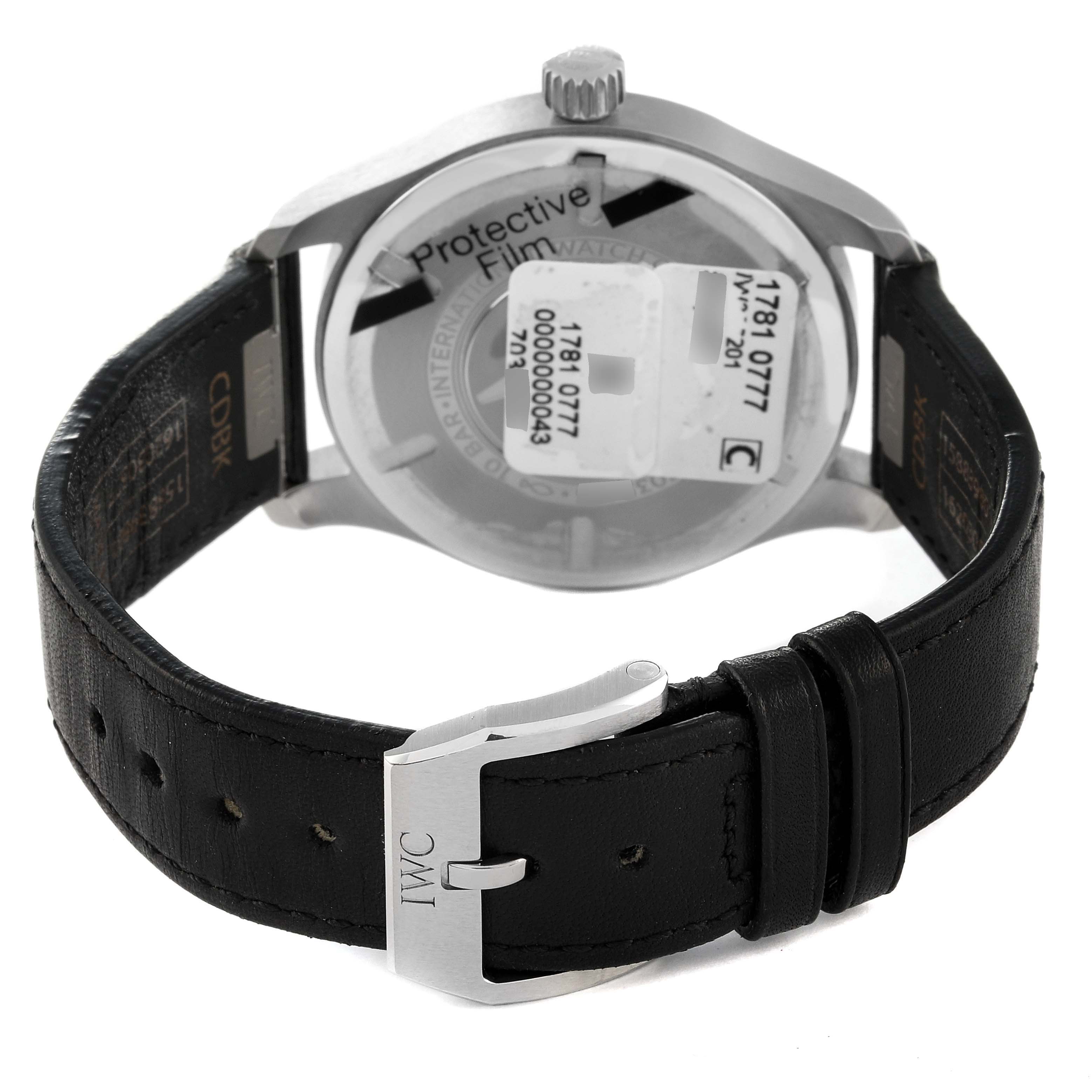 The image shows the back view of the IWC Pilot IW328201 Men
s Stainless Steel Black Dial IW328201 Men
s Stainless Steel Black Dial watch, highlighting its buckle, leather strap, and case back with protective film.