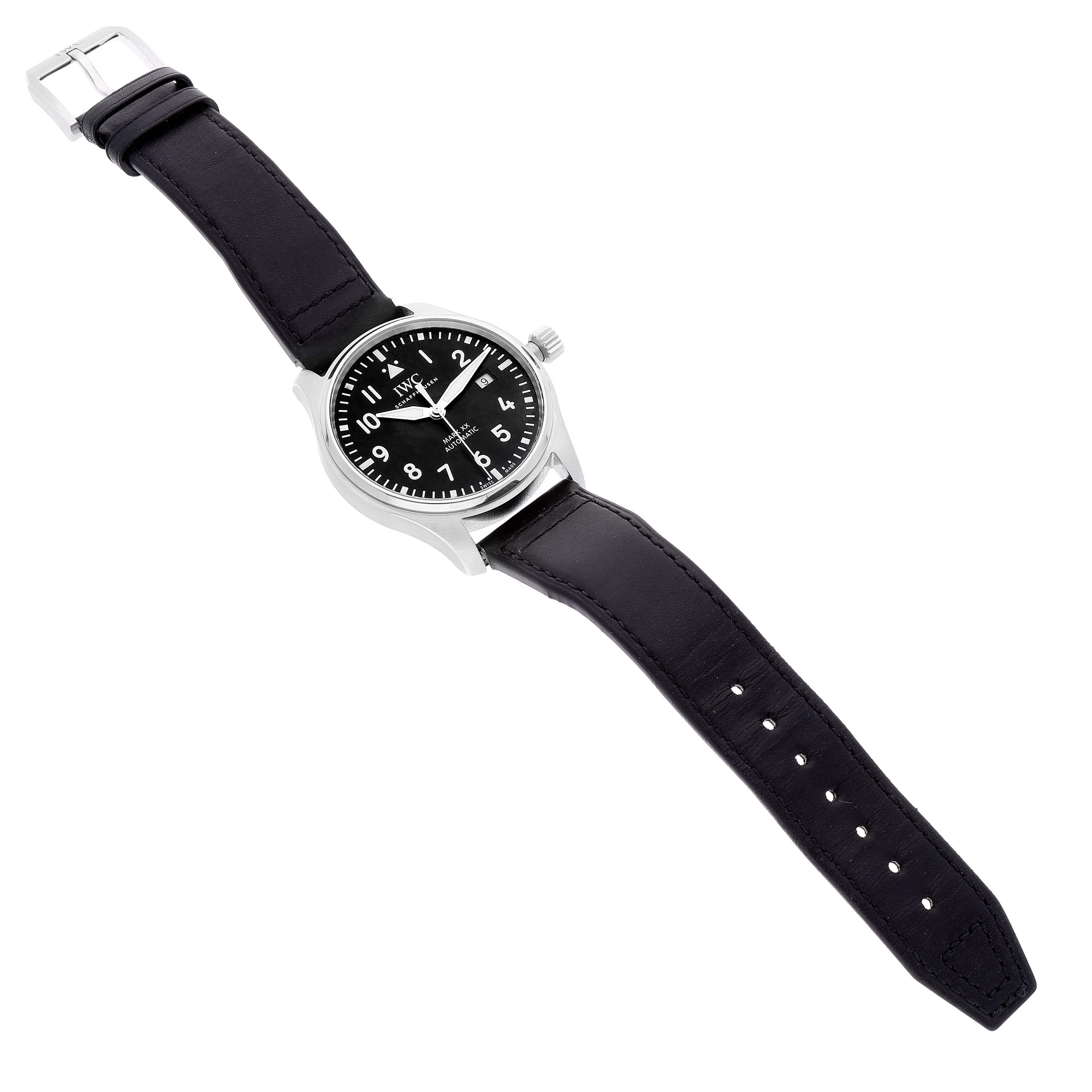 The image shows an IWC Pilot IW328201 Men
s Stainless Steel Black Dial IW328201 Men
s Stainless Steel Black Dial model wristwatch from a top-down angle, highlighting its black dial, stainless steel case, and black leather strap.