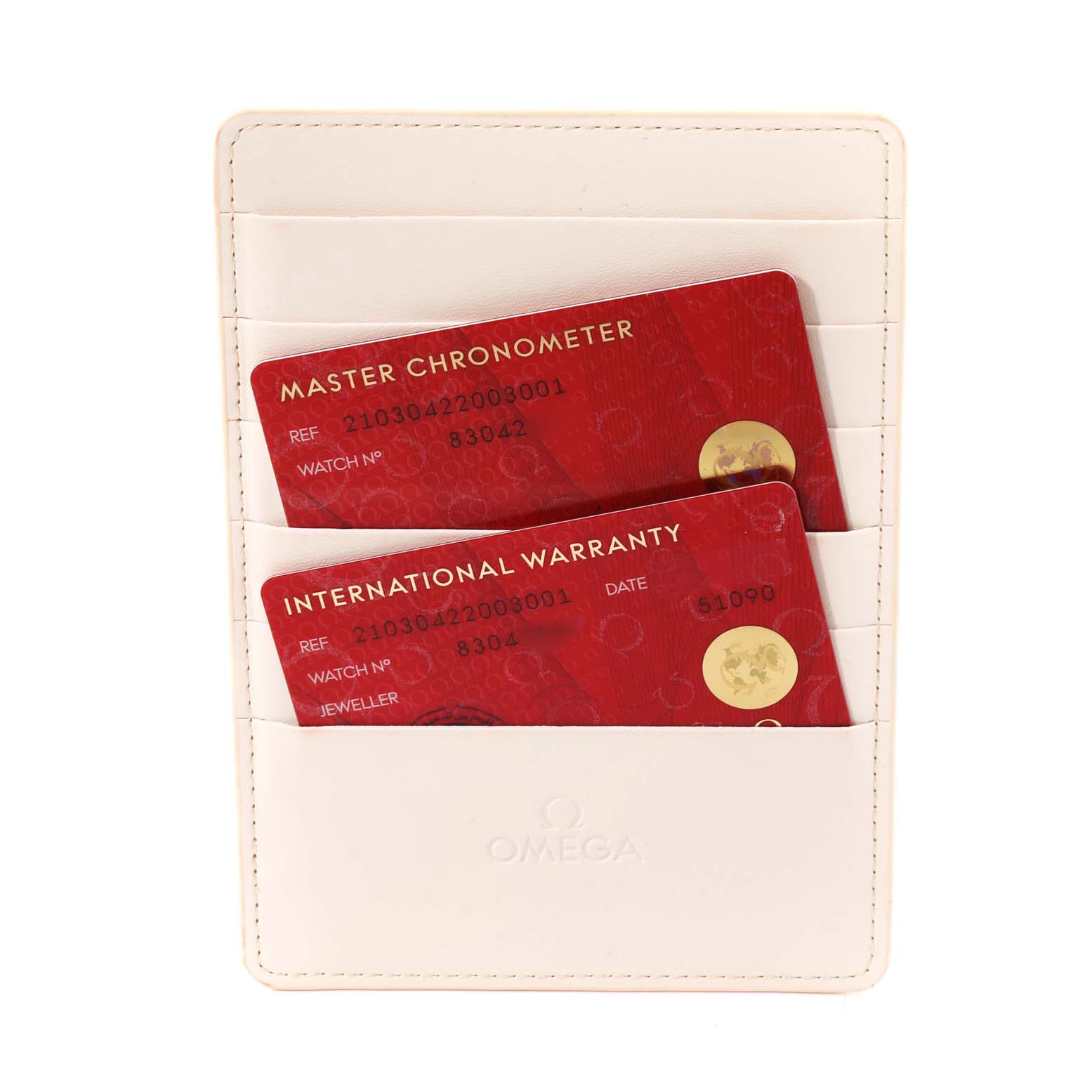 The image shows two red cards, marked "Master Chronometer" and "International Warranty," in a white Omega cardholder for the Seamaster model.