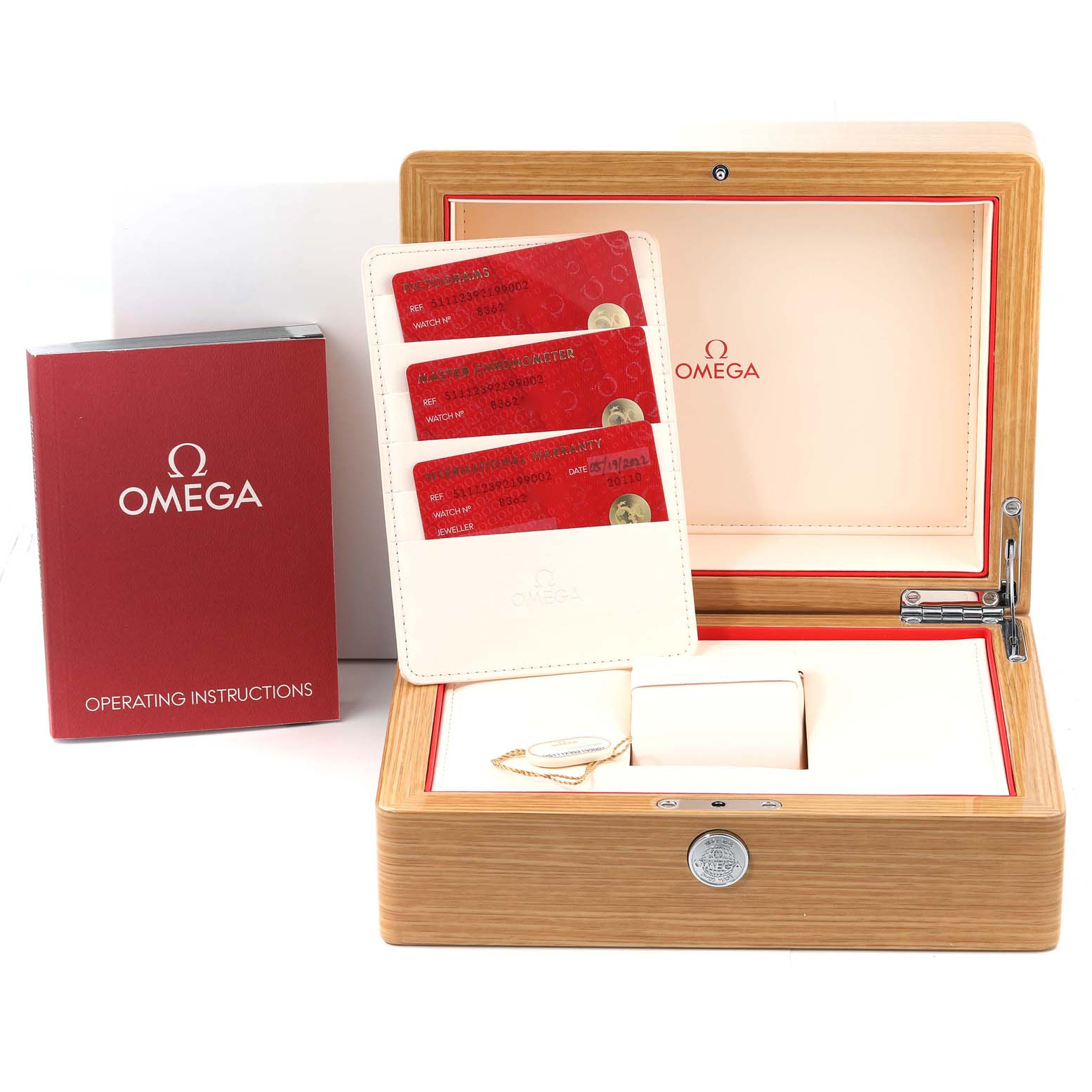 The image shows an Omega Museum 511.12.39.21.99.002 Men's Stainless Steel Grey Dial 511.12.39.21.99.002 Men's Stainless Steel Grey Dial model watch’s box, operating instructions, and authenticity cards.